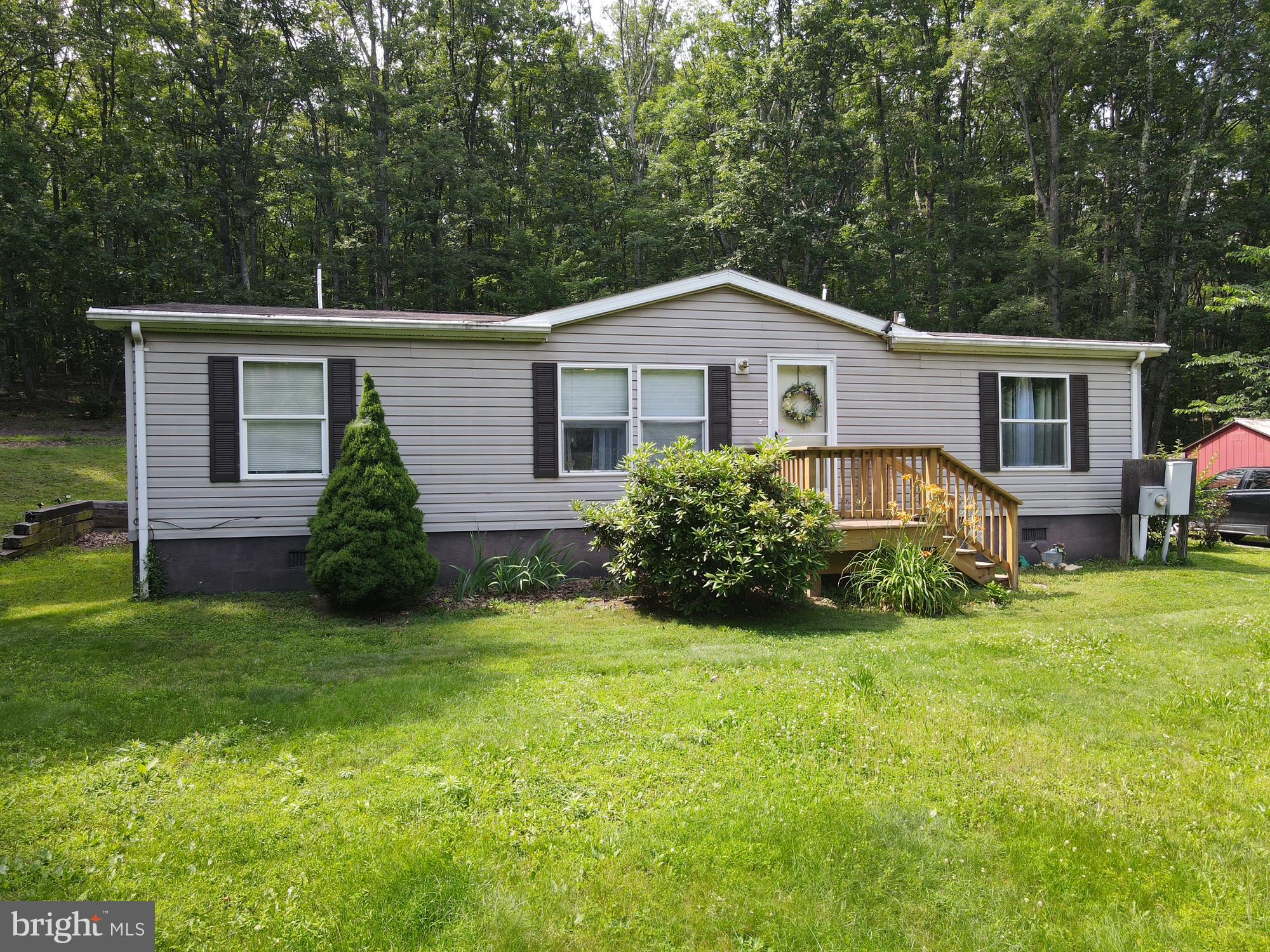 Call now to see this priced to sell manufactured home on 6 private and wooded acres. The home has 3 bedrooms, 2 bathrooms, living/dining/kitchen area. Enjoy spending time on the deck located on the side of the house.