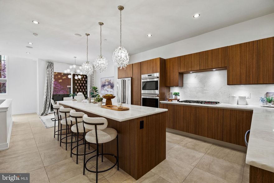 Located in the sought-after, and conveniently located, Bella Vista neighborhood, this striking modern townhome, built in 2016, offers over 3,500 sq ft of luxury living across four levels, all accessible by a private elevator. With 4 bedrooms, 4 full baths, 3 half baths, and a 2-car garage, the home is designed for both comfort and sophistication.

The main level features sun-filled living and dining areas with soaring ceilings, hardwood floors (replaced in 2021), a sleek eat-in kitchen with Viking/Wolf appliances, and an oversized island. A stylish sunken living room with a gas fireplace and built-ins adds charm and functionality.

The primary suite spans the entire top floor and includes dual walk-in closets, a spa-like bath with soaking tub, double vanity, and waterfall shower. Two additional en suite bedrooms, a dedicated laundry room, and powder rooms on multiple levels provide ease and convenience.

A private sauna, massive finished basement with granite bar and wine storage, and a show-stopping rooftop deck with panoramic city views elevate the lifestyle. Smart tech, custom shades, updated lighting, and a Control 4 system complete this stunning residence. With 1 year remaining on the tax abatement, this is luxury city living at its finest.