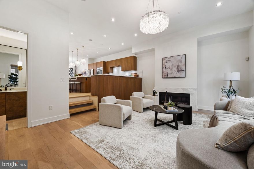 Located in the sought-after, and conveniently located, Bella Vista neighborhood, this striking modern townhome, built in 2016, offers over 3,500 sq ft of luxury living across four levels, all accessible by a private elevator. With 4 bedrooms, 4 full baths, 3 half baths, and a 2-car garage, the home is designed for both comfort and sophistication.

The main level features sun-filled living and dining areas with soaring ceilings, hardwood floors (replaced in 2021), a sleek eat-in kitchen with Viking/Wolf appliances, and an oversized island. A stylish sunken living room with a gas fireplace and built-ins adds charm and functionality.

The primary suite spans the entire top floor and includes dual walk-in closets, a spa-like bath with soaking tub, double vanity, and waterfall shower. Two additional en suite bedrooms, a dedicated laundry room, and powder rooms on multiple levels provide ease and convenience.

A private sauna, massive finished basement with granite bar and wine storage, and a show-stopping rooftop deck with panoramic city views elevate the lifestyle. Smart tech, custom shades, updated lighting, and a Control 4 system complete this stunning residence. With 1 year remaining on the tax abatement, this is luxury city living at its finest.