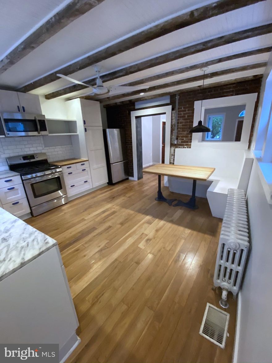 Location, Location, Location! This lovingly updated Fishtown home sits at the end of the row just one block from Girard and Frankford on quiet tree-lined street.  Wide, bright main floor with new half bath, salvaged hardwoods and large modern kitchen with custom built-in dining!  Step out to the freshly-painted patio  with plenty of space to lounge and  bonus wide easement to street, making bike/stroller parking a breeze! Unfinished basement off the kitchen has washer & dryer and plenty of storage space.  Upstairs, find two bedrooms with ample closet space, newly refinished original hardwoods and the updated full bathroom.  Large third floor flex space for a third bedroom, playroom or office!  Move right in and enjoy this special home, or collect over $2k per month as an easy income property!    Motivated sellers! - Bring an offer!