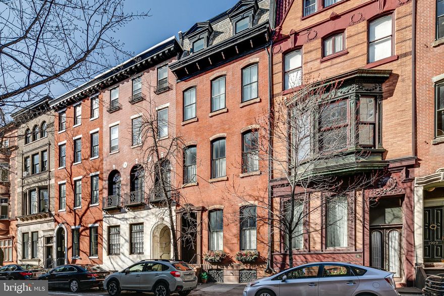 A grand, suburban feel in the heart of Rittenhouse Square - 1913 Spruce St has it all! This remarkable home is located only 99 steps from Rittenhouse Square, making it one of the few single-family homes this close to the park. 1913 Spruce St is a 4-story gem with 5,800+ SqFt of space, offering 4 bedrooms, 3 full bathrooms, 2 half bathrooms, a 2-car garage, and over 1,000 SqFt of outdoor space.   The first floor hosts a sitting room, a bedroom, an office, a full bathroom, and a mudroom with an elevator. At the back of the property is a 2-car garage and a private breezeway that connects to Manning St.   Make your way up to the second floor, and you'll find the dining area and an impressive modern chef’s kitchen with custom cabinetry, stainless steel appliances, the home’s AV/Music system, which plays throughout the house, and a private deck. Past the laundry room and powder room, you'll discover the expansive main living room. This area is a true showpiece!   Located on the third floor are two generously-sized, well-lit bedrooms with excellent closet space and a full bathroom. The upper section of this level is dedicated to the primary suite, where you will find an open bathroom with a huge double vanity, a glass-enclosed rainfall shower, and a water closet. Further down the circular entryway are two walk-in closets, which leads you to the spacious master bedroom.   A massive recreation room awaits you on the top level, which is well set-up for a den, media room, game room, gym, or possibly 5th & 6th bedrooms. Off this room, there's a bi-level deck with a gas line and a dumbwaiter that is serviced from the kitchen. Offering skyline views, this deck has endless room for relaxing and entertaining. This home also features an unfinished basement that stretches the home's length, providing abundant storage space.