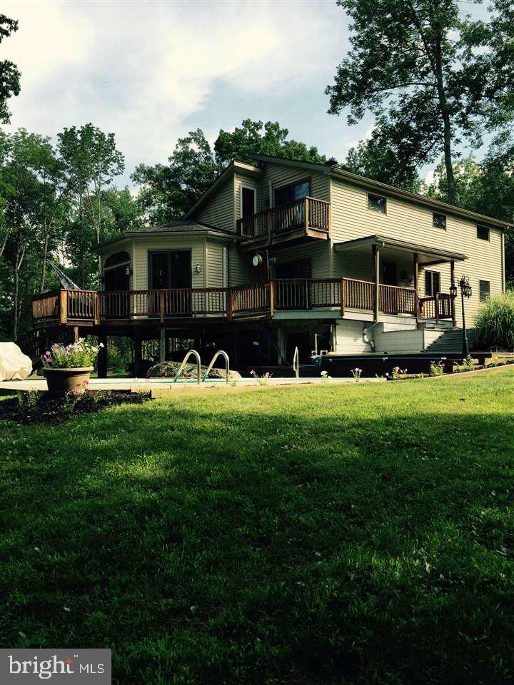 This house was built by a master craftsman and has custom features throughout. privacy and creek views/ frontage make this a must buy. in ground pool, insulated separate wood shop, eagles and otters are the only neighbors you see. easy access to 15 but on scenic Marsh Creek make this home ideal for MD commuters. Efficient heat pumps and wood stove.
