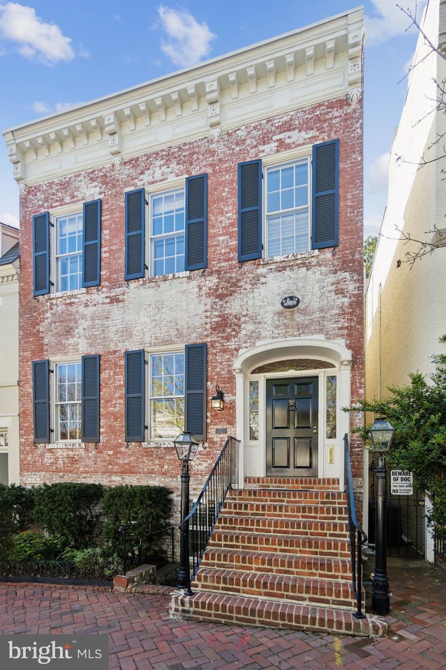 OPEN HOUSE THIS SUNDAY - 06/11 (1:00-3:00PM) This 1887 Georgetown townhouse blends historic elegance with refined updates, including a brand-new gourmet kitchen and Waterworks baths. Boasting 2,400 square feet of stunning living space, the residence features three bedrooms, two full bathrooms, and two powder rooms. Impeccably renovated yet rich in historic character, the home showcases its original wood flooring and windows, custom built-ins, and four period mantel gas-log fireplaces throughout. A pair of traditional natural gas lamps flank the main entrance, welcoming you into the gracious main level. The expansive double living room is framed by soaring ceilings, Venetian-painted walls, and Jefferson-style windows that flood the space with light. The sunlit lower level opens through French doors to a serene, landscaped patio with a fountain—perfect for al fresco dining. The brand-new gourmet kitchen features Carrara marble counters, Miele appliances, and a glass-door Sub-Zero refrigerator. A versatile guest bedroom (or study) includes an en-suite powder room and additional storage. The upper level offers two spacious bedrooms, each with its own Waterworks-designed full bath. The primary suite overlooks the garden and enjoys the soothing sound of the outdoor fountain. It includes an elegant custom built-in wardrobe and leads to an en-suite bath with a large, luxurious shower. The secondary bedroom features an expansive walk-in dressing closet with full-height mirrors, several custom built-in bookcases, ample cupboard storage, and a period mantel fireplace. The adjacent bathroom includes heated floors and a deep soaking tub for relaxation. Thoughtful upgrades include double storm windows, a new roof, Carrier HVAC, water heater, and chimney liner (2021). Rental parking is available just two minutes away. A timeless Georgetown classic—where history, charm, and modern comfort meet.