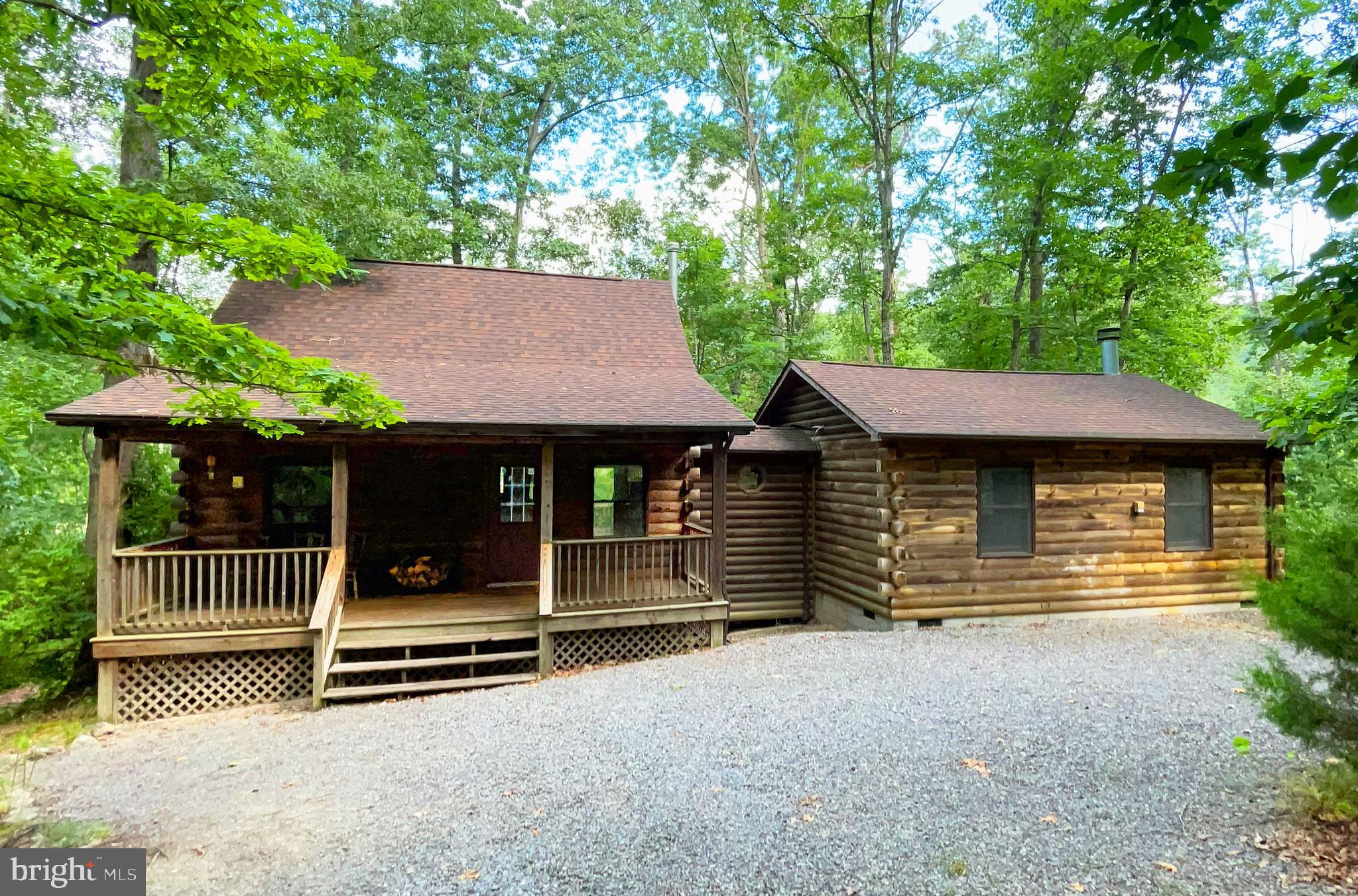 IT'S TIME TO RELAX AND ENJOY LIFE! THIS RUSTIC LOG HOME ON 5 WOODED ACRES IS EXACTLY WHAT YOU'VE BEEN LOOKING FOR. Private and secluded yet convenient to Rt. 50 and only a short drive to the town of Capon Bridge and the Cacapon River. Backs to Dillons Run, a stream stocked for fishing. Perfect for weekend getaways or year-round living. Open floor plan with cathedral ceilings and two stone-front fireplaces - one wood-burning and the other a gas log. Beautiful pine floors, walls and ceilings. Dramatic great room with adjoining 12x10 screened porch. Two bedrooms, including a carpeted loft suite with a sitting room and bath with a jetted tub and separate shower. Plenty of outdoor entertaining areas - 8x24 covered front porch, 20x10 rear deck off the kitchen, and a 14x12 stone patio. The walk-out basement has a bath rough in and propane heater and offers possibilities for a workshop or finishing as a family room or home theater. New 30-year shingle roof and new water treatment system in 2018. Crawlspace under great room has new insulation.