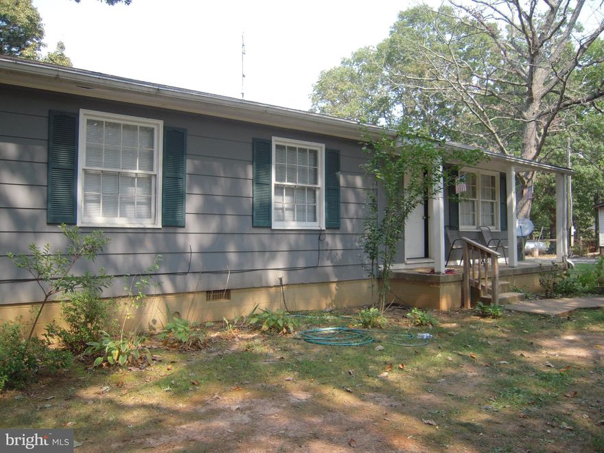 Great investment or starter home on  one acre of flat land. Comfortable home with living and dining room combination and three bedrooms and a full bathroom.  Spacious gallery kitchen with enclosed closet with Washer and Dryer.  Kitchen entrance to back porch overlooking the perfect backyard oasis. All rooms Freshly Painted.  Parking space for your trailer or RV/camper.  No Home Owners Association dues.  Great location and country living and at the same time, very close to all conveniences.  Seller providing a one year Home Warranty.  The hotwater heater is approximately 2 years old.