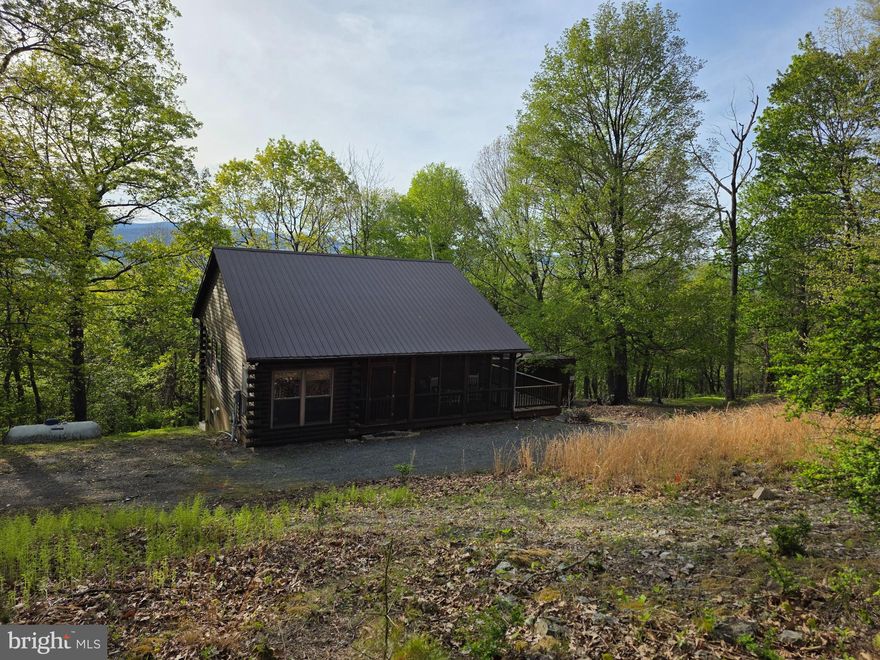 Beautiful Log Siding Cabin located in a secluded Mountain development just minutes from the town of Franklin.  If you need to stay connected, there's new Fiber Optic cable being run throughout the development! The cabin comes fully furnished, so just pack your bags for a peaceful & relaxing getaway or it would make a great full time residence if you're looking for a slower pace of life.  The screened in porch on the front of the cabin is like it's own separate room with access to the wrap around deck. It's a great place to enjoy the cool evening breezes of summer and the beautiful fall foliage. From there, you enter an inviting mudroom area by the kitchen.  A place to kick off your shoes before you settle in. The kitchen has a full size refrigerator, stove and beautiful solid wood cabinetry. Open the French doors in the living room to further extend the living area to the full length covered deck across the back of the home.  You're sure to enjoy the wooded mountainside view while relaxing  with a favorite beverage or enjoying a meal.  Just off of the kitchen/living room area, you'll find 2 bedrooms with a full bath. Downstairs, you'll enter into the bonus room to use in whatever way suits your needs. Perfect for a game room, family room, hobby area, etc.  The third bedroom has French doors leading out to the lower covered patio area that also extends the full length of the cabin.  The utility room is located just off the bonus room and includes the stackable washer/dryer. A shared Spring of good quality and production, supplies plenty of water to the cabin. There's a large shed next to the cabin that you can use for storage or turn into a bunkhouse. The development offers a great place to hike trails or bring your recreational vehicle to get around more quickly to explore. Don't miss an opportunity to own your piece of Heaven in West Virginia. Also located near George Washington National Forest, 30 minutes to Seneca Rocks Recreational Center, 1 hour from Blackwater Falls State Park, etc. Lots of great fishing and hunting in the area. Some covenants & restrictions will apply.