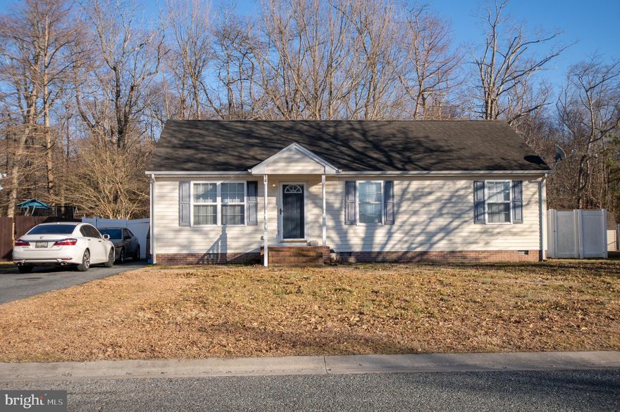 Welcome to this charming home in Crisfield, Maryland! This inviting single-level residence offers comfortable living with a bright, open feel and tasteful finishes throughout. Inside, you’ll find attractive wood-style flooring, neutral tones, and a spacious living area featuring a ceiling fan, built-in shelving wall, and plenty of room for relaxing or entertaining.

Step outside to enjoy a generously sized backyard bordered by a white privacy fence and peaceful wooded backdrop—perfect for gatherings, pets, or simply unwinding. A storage shed provides added convenience for tools and outdoor equipment, while the front exterior showcases classic curb appeal with shutters, a covered entry, and off-street parking.

If you’re looking for a cozy 3 bedroom 2 bath home with both indoor comfort and outdoor space, this property is a must-see! Property is being sold as-is.
