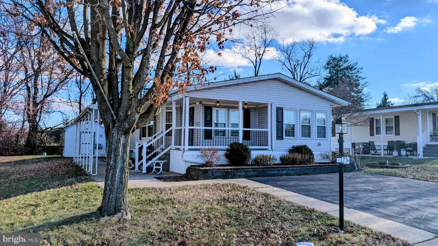 Discover the charm of this inviting double-wide manufactured home nestled in the serene Winterset Farms community. Built in 1990, this well-maintained ranch-style residence offers a perfect blend of comfort and functionality, making it an ideal retreat. Step inside to find a spacious open floor plan that seamlessly connects the living, dining, and kitchen areas. The cozy living room features a gas fireplace, perfect for those chilly evenings. The kitchen is a chef's delight, equipped with modern appliances including a built-in microwave, cooktop, and wall oven, along with an island for additional prep space. Enjoy casual meals in the breakfast area or host dinner parties in the formal dining room. This home boasts two generous bedrooms, each with ample closet space, including a walk-in closet in the master suite. The two full bathrooms feature a convenient tub-shower combination, ensuring comfort for all. Outside, the property is adorned with a welcoming porch and patio, ideal for morning coffee or evening relaxation. An awning provides shade, while a shed offers extra storage for your outdoor essentials. With a private asphalt driveway accommodating two vehicles, convenience is at your fingertips. Located less than 15 miles from the airport, this home combines tranquility with accessibility. Experience the warmth and comfort of this delightful property, where every detail has been thoughtfully designed for your enjoyment.