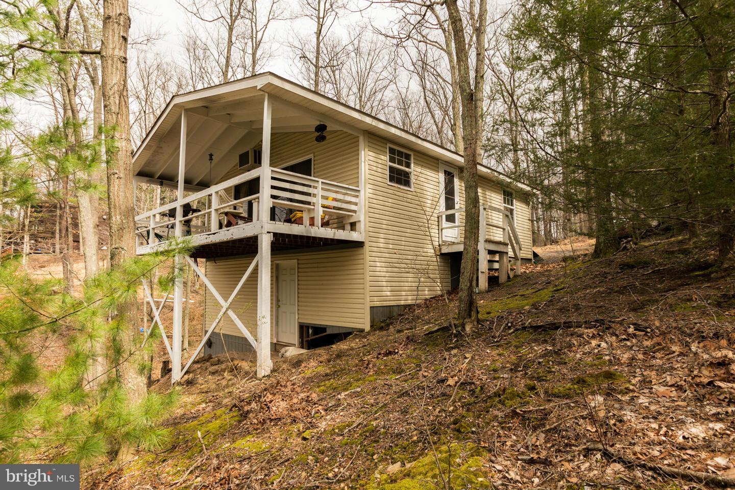 Come and relax on the weekends or all year long at this 2 bedroom 1 bath cabin. Cathedral ceiling in the living room with fireplace and covered deck overlooking the lake! This cabin comes with many amenities such as lake access, baseball field, boat slip and much more! Come enjoy the peaceful living!