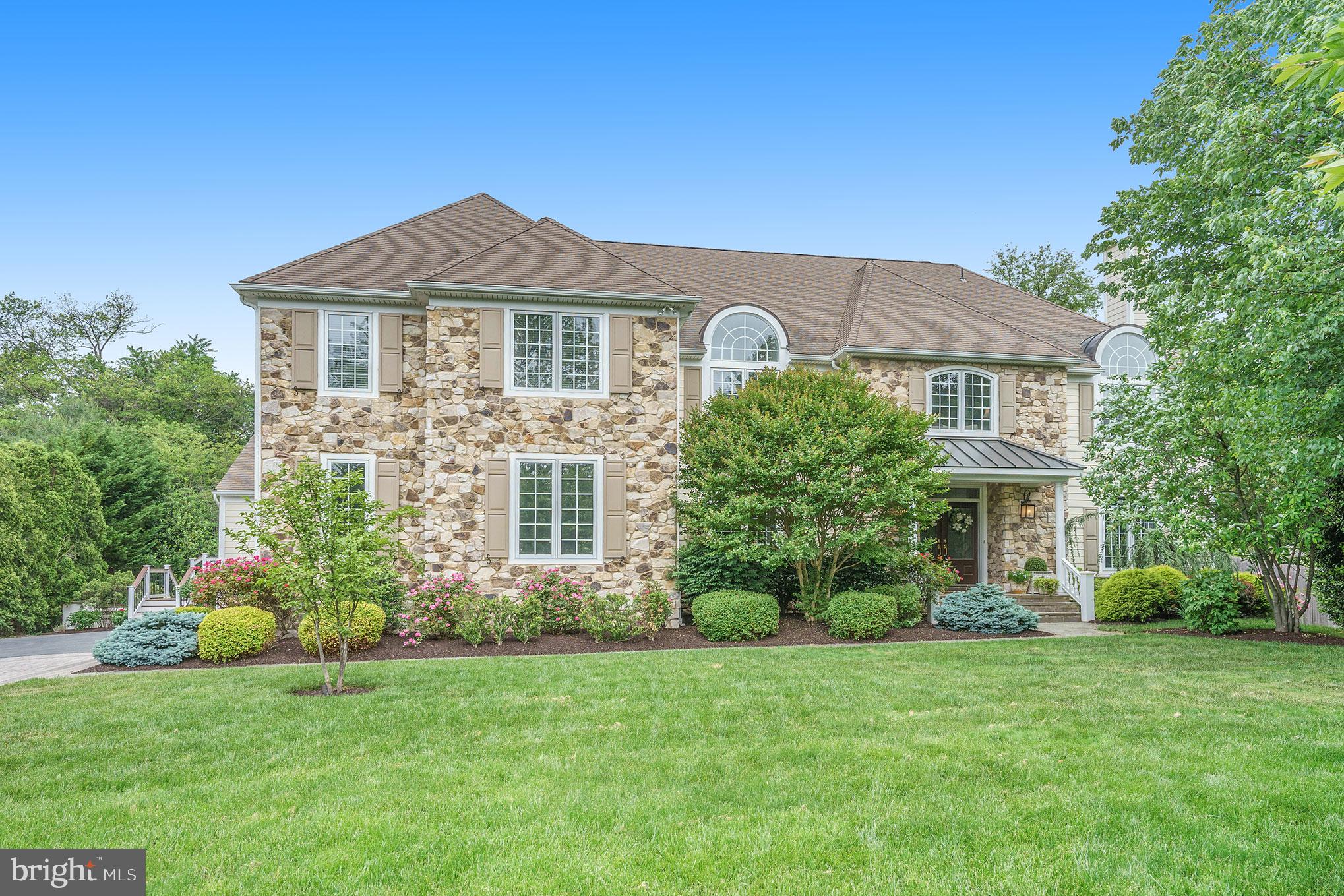 Traditional elegance shines in Villanova! This exceptional 6-7 bedroom, 7.2 bath residence is set amidst beautifully appointed grounds in a small exclusive enclave of only 9 homes. The original builder’s model for this development boasts many upgrades, including custom millwork throughout. This fresh, modern floor plan includes two home offices, four living areas, chef's kitchen, au pair suite, finished lower level, fantastic storage, and abundant natural light. The front double door opens to a sensational grand foyer and curved staircase. The dining room features impressive crown molding, wainscoting, tray ceiling, and access to the butler’s pantry. The living room’s nearly floor-to-ceiling windows bathe this space in light and here you can enjoy a travertine fireplace, the first of 3 fireplaces. French doors lead to a large powder room and beyond that, an office with floor-to-ceiling bookcases, crown moldings, and a lush green view that perfectly aids concentration while working. French doors from here lead to the all-season sunroom. With its floor-to-ceiling windows, French doors to the expansive deck, and views of the grounds, your day might have its beginning, middle, and end in this bright and delightful space.
The sunroom connects to a dramatic two-story family room. This is the center of the home, with wide plank oak hardwood floors and a remarkable custom inlaid border. A travertine fireplace centers the space while dramatic two-story Palladian windows and skylights let the light pour in and allow scenic views of nature all year round. A fantastic chef’s kitchen is fully equipped with granite counters and premium appliances, an office station, an open breakfast area with sliders to the deck, plus skylights, and a huge picture window bringing the outdoors in. Thermador, Sub Zero, French country range hood, double oven; all the expected appointments are here for extraordinary meals and entertaining. The connectivity between the main level rooms sets the stage for either casual and comfortable relaxation with family or lavish hosting with many friends. Off the kitchen are a large mudroom, powder room, storage, and the first of two laundry rooms. The second level houses five large bedroom suites - all with en-suite baths, carpeting, large closets, and large windows. Also, a second large laundry room with cabinetry. The primary bedroom suite is over 1200 sq feet. It includes an office, large sitting room, dressing and vanity area, his and hers walk-in-closets, and deluxe travertine-clad spa bath with a shower for two, Jacuzzi tub, skylights, and soothing neutral colors for a serene retreat. The finished third floor is a bright and open au pair suite featuring a large bedroom, full bath, living area with hardwood floors and skylights, and kitchenette, plus a large storage room. The full, finished lower level boasts multiple living and recreational areas: large workshop/hobby room, family room, roughly 1400-square-foot storage room, wine storage, and a daylight rec room that could be a gym/playroom/office/or a 7th bedroom, with a full bath adjacent to it. Outside, the expansive, maintenance-free deck runs nearly the length of the whole house. A stunning courtyard terrace includes a gorgeous garden, built-in seating, and fountain, while a dining pergola beckons beyond. There are noteworthy specimen plantings all around, while the landscape design and lot positioning overall take strategic advantage of natural light. This 20-year-old beauty has had all stucco replaced with Hardie board in the last 3 years. This location is walkable to the brand new Black Rock Middle School set to open in Fall 2022. Beyond the gorgeous natural surroundings and gracious living space, you’ll enjoy close proximity to shopping and fine dining, some of the best public and private schools in the nation, beautiful parks, all major transportation routes, King of Prussia, and Center City.