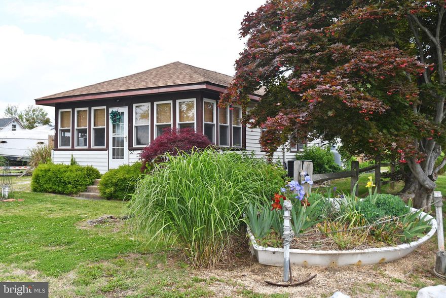 Affordable & adorable summer cottage.  Ready to move right in and start enjoying life on the Chesapeake Bay.  There is a gas furnace and central air conditioning so you can stretch the seasons for maximum enjoyment.  A rear patio offers the perfect spot for your morning coffee or just catching up with the neighbors.  You also have a carport on the side of the cottage and access to the rear yard via alley and double gate in the fence.  Terrific sandy beach access is included and you also have the option of joining the yacht club to gain access to a more private beach area and potential slip rental.  Your premiere gateway to the Eastern Shore!