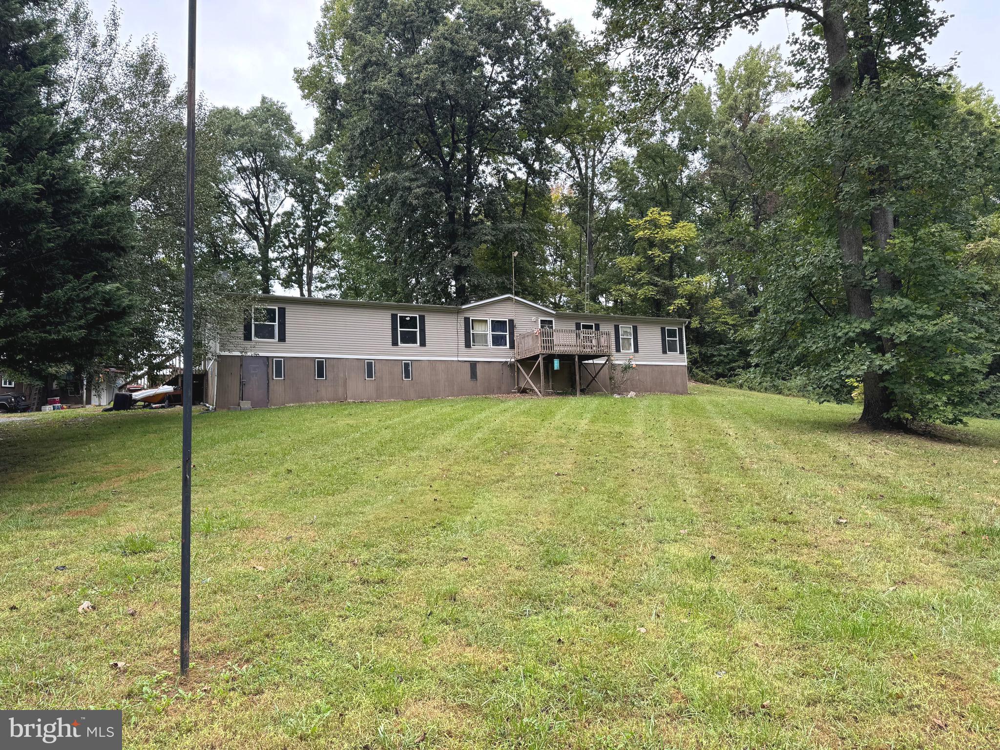 Great investment opportunity. This double wide sits on a beautiful 2.21 acre lot. This house features 4 bedrooms and 2 bathrooms. Don't miss this opportunity. Also featuring a shop/storage building in the back.