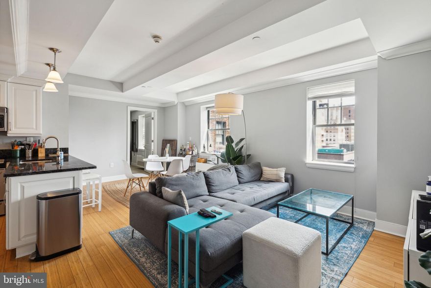 Luxurious two bedroom, two and a half bathroom showcasing sunrise city views on a high floor of The Warwick! This expansive home boasts hardwood floors and tasteful finishes and features throughout. Enter into a generously combined living and dining room with beautiful ceilings, oversized windows and a large coat closet. The updated kitchen offers white cabinetry, stainless steel appliances, black granite countertops, and a breakfast bar. The lavish primary suite enjoys an incredible custom walk-in closet and ensuite marble-appointed bathroom with a shower/tub and oversized single vanity. The spacious second bedroom has a walk-in closet and ensuite bathroom appointed in marble with stall shower. Additionally, there is a powder room that provides access to the stacked washer/dryer.  Residents of The Warwick enjoy the same amenities as hotel guests including 24-hour doorman service, a state-of-the-art fitness room, room service, maid service, valet parking, car service, and the use of three restaurants on the ground floor for additional fees.