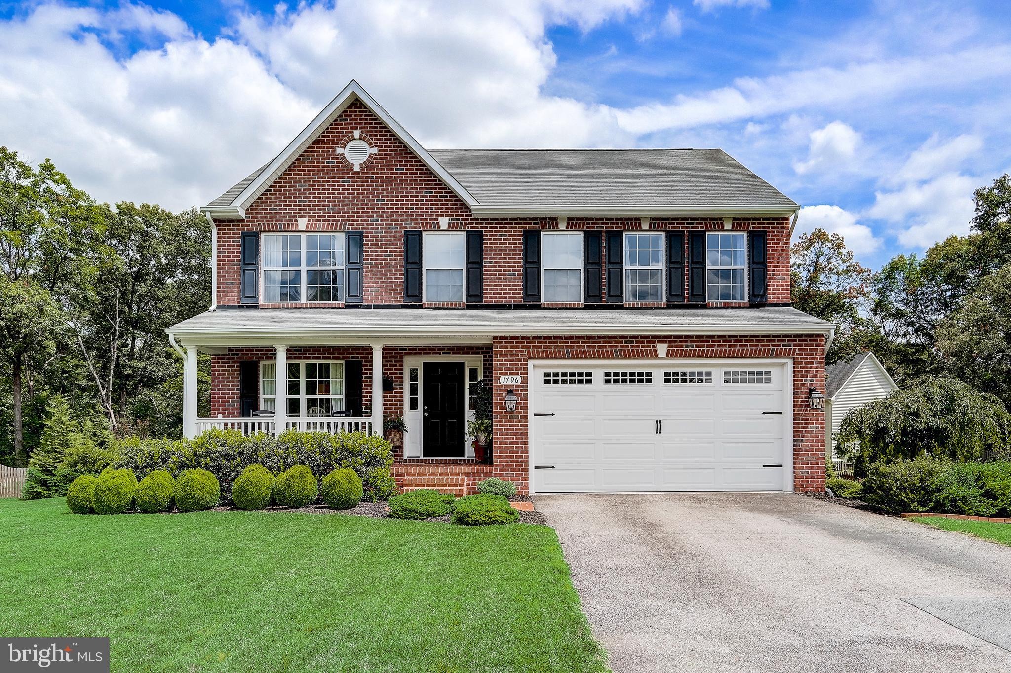 Step into timeless charm and modern elegance with this stunning colonial home featuring a classic all brick front porch and steps and nestled on a beautifully landscaped 1/3-acre lot backing to mature trees, offering a serene natural backdrop. Inside, you'll find high-end upgrades throughout, blending sophisticated design with everyday comfort. From the designer finishes, custom paint colors, hardwood flooring throughout the main level, and stylish, custom lighting to the gourmet kitchen, spa-inspired baths, and fully finished lower level with guest suite, no detail has been overlooked. Just off the entry, a spacious front room offers flexible use—perfect as a formal dining area, den, or study—seamlessly connecting to the main living spaces beyond. The inviting family room features a cozy fireplace with an elegant white mantle surround, creating a warm and welcoming atmosphere. From there, the layout opens to a sun-drenched sunroom, where an abundance of windows capture views of the beautifully landscaped backyard and tree-filled surroundings, and sliding glass doors lead to a two-level deck. This bright and airy space is a true highlight of the home, offering an ideal spot for morning coffee or simply enjoying the changing seasons in comfort. At the heart of it all, the kitchen boasts a custom-made 9 foot long island with built-in shelving and cabinetry, stool seating, along with an additional breakfast bar—both perfect for gathering and entertaining. The kitchen’s open sightlines to the sunroom make it a central hub that connects the beauty of the outdoors with everyday living. You’ll also find a convenient half bath on this level. Upstairs, the home offers four generously sized bedrooms and a well-appointed hall bath with a tub/shower combination and a convenient laundry closet. The private owner's suite features a spa-like en-suite bath with a corner soaking tub, separate shower, and a huge walk-in closet. The lower level of the home expands the living space with a versatile recreation area featuring luxury vinyl plank flooring—ideal for a workout zone, play area, or hobbies—while the other space is carpeted and comfortably set up with a couch for TV watching and relaxation. There’s also a nicely sized bedroom with a walk in closet and full egress window bringing in natural light, and a full bath—making it a perfect setup for guests, in-laws, or a private home office. Designated high school is Severn Run High School.