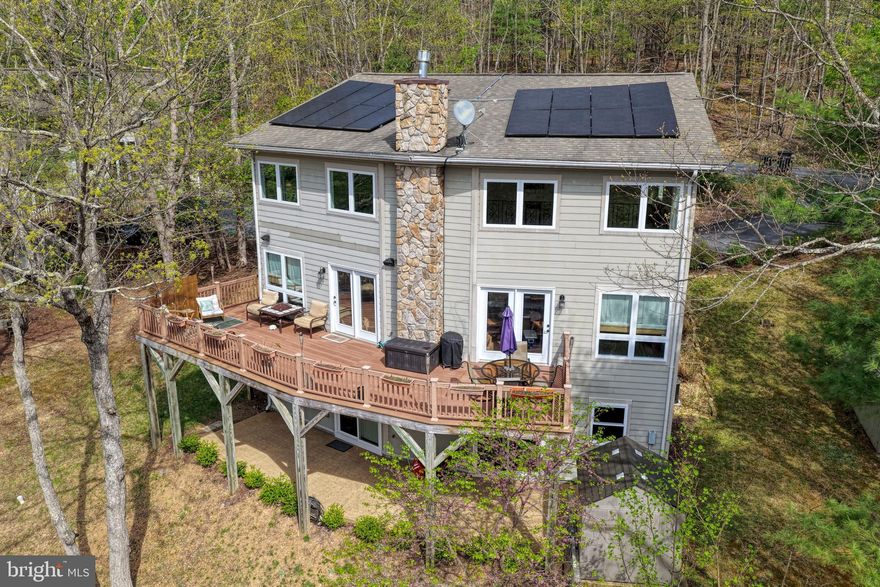 Welcome to 167 Williams Ln. This is an amazing single family home with modern features, energy efficient systems, and amazing mountain views just minutes away from Bryce Resort! Enjoy year round leisure with plenty of outdoor activities! At the Bryce Resort and you will have access to swimming pools, skiing, restaurant and bar, a private airport, bike routes, and wine trails. Enjoy near by Laura Lake great for fishing and canoeing! Enjoy a permanent residence or a vacation home only 1hour 45min away from Dulles Airport.
This home is beautiful and shows pride in ownership! Expansive ceilings welcome you with mountain views in a large two story ceiling open floor plan main level. Or go outside to your large deck that expands from one side of the home to the other, great for hosting and entertaining. Plenty of open space on the main level with a large gas fireplace in the living room, main level suite complete with primary bath, main level laundry, modern kitchen, a guest powder room,  and a personal gas fireplace in the primary bedroom. Kitchen is complete with granite countertops, double wall oven, electric cooktop, disposer, dishwasher, and side by side refrigerator. Upper level has a spacious open loft area with amazing views from large windows, and a bedroom with a jack and jill bathroom. Walk-out basement is great for entertaining and includes a wet bar, bedroom suite, full bathroom, and a generous utility room. This home is on public water and public sewer. Heating a provided by a propane tank service. Propane service is about $1,000 a year for furnace heating, 2 fireplaces, and water heater. Enjoy almost no cost Dominion Energy bill with a modern solar panel system that provides 99% of the energy you will need throughout the year. The solar panels are owned, but currently being financed. Solar panel finance contract will convey to new owner and the seller will pay the transfer fee. There are two sets of laundry, a stackable washer dryer unit on the main level and a washer dryer in the basement. Washer and dryer in basement do not convey. Some blinds do not convey. A home warranty will convey to the new owners that expires in June 2027 Built in 2005, this home brings you modern construction materials like permanent concrete pour foundation, hardiplank exterior siding, architectural roof shingles, double hung insulated windows, and modern electrical and mechanical services.