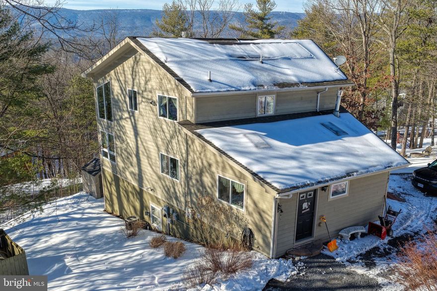 Welcome to 167 Williams Ln. This is an amazing single family home with modern features, energy efficient systems, and amazing mountain views just minutes away from Bryce Resort! Enjoy year round leisure with plenty of outdoor activities! At the Bryce Resort and you will have access to swimming pools, skiing, restaurant and bar, a private airport, bike routes, and wine trails. Enjoy near by Laura Lake great for fishing and canoeing! Enjoy a permanent residence or a vacation home only 1hour 45min away from Dulles Airport.
This home is beautiful and shows pride in ownership! Expansive ceilings welcome you with mountain views in a large two story ceiling open floor plan main level. Or go outside to your large deck that expands from one side of the home to the other, great for hosting and entertaining. Plenty of open space on the main level with a large gas fireplace in the living room, main level suite complete with primary bath, main level laundry, modern kitchen, a guest powder room,  and a personal gas fireplace in the primary bedroom. Kitchen is complete with granite countertops, double wall oven, electric cooktop, disposer, dishwasher, and side by side refrigerator. Upper level has a spacious open loft area with amazing views from large windows, and a bedroom with a jack and jill bathroom. Walk-out basement is great for entertaining and includes a wet bar, bedroom suite, full bathroom, and a generous utility room. This home is on public water and public sewer. Heating a provided by a propane tank service. Propane service is about $1,000 a year for furnace heating, 2 fireplaces, and water heater. Enjoy almost no cost Dominion Energy bill with a modern solar panel system that provides 99% of the energy you will need throughout the year. The solar panels are owned, but currently being financed. Solar panel finance contract will convey to new owner and the seller will pay the transfer fee. There are two sets of laundry, a stackable washer dryer unit on the main level and a washer dryer in the basement. Washer and dryer in basement do not convey. Some blinds do not convey. A home warranty will convey to the new owners that expires in June 2027 Built in 2005, this home brings you modern construction materials like permanent concrete pour foundation, hardiplank exterior siding, architectural roof shingles, double hung insulated windows, and modern electrical and mechanical services.