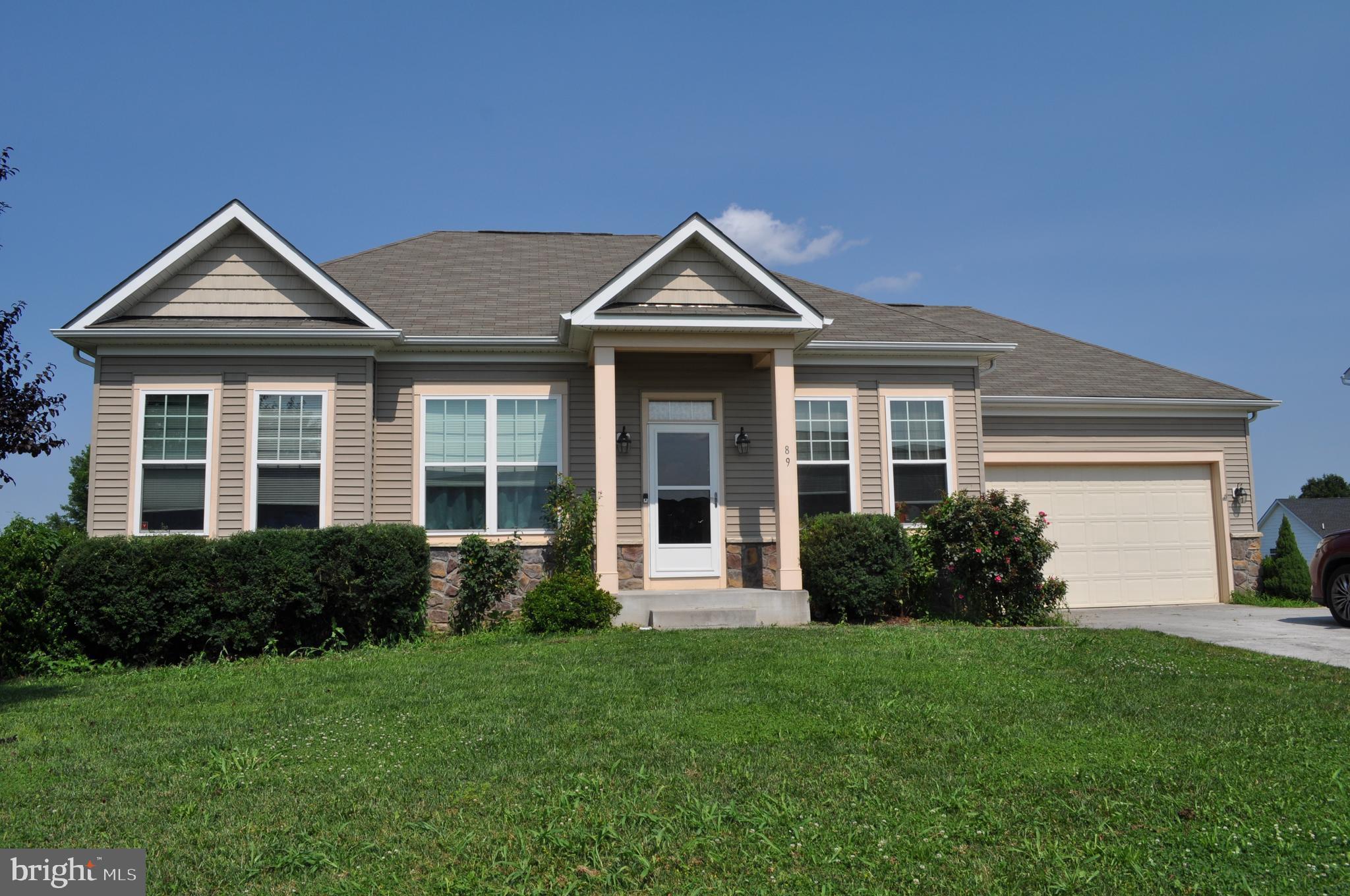 PRICED REDUCED AGAIN! MOTIVATED SELLER! This 4 BR 3 BA rancher is located just a few driving minutes from the VA Medical Center and features wheelchair access to the main level through the 2 car garage and into the basement from the wrap-around sidewalk. There are 2 primary bedrooms, one with an ensuite bathroom and walk-in closet. One is located on the main level, and the other is in the partially finished and recently remodeled basement with a full bath, adding more finished living space with amazing potential. Enjoy the dawn of a new day from the 8' x 16' deck off of the family room. There is a concrete porch and patio off the basement living area. Curl up on those cold winter evenings near the wood-burning fireplace, which is located in the main level living area. The community offers a playground for the youngsters and a walking trail so you can get those steps in, and if you love to golf, there is also a golf course nearby.