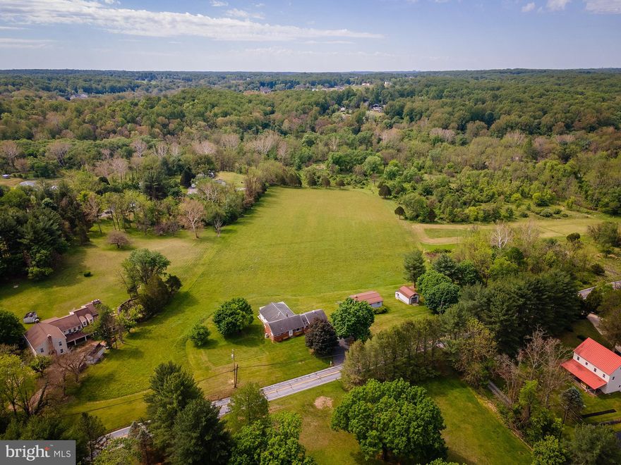 CThese opportunities do not come available often in Brookeville! Set on 9 flat grassy acres, 1112 Gold Mine Rd offers the space, outbuildings, versatility, and setting so many search for. The expansive brick ranch home features abundant natural light, a spacious kitchen/dining addition with stainless steel appliances, hardwood flooring, ample cabinetry, and a large rear deck overlooking the stunning property. The main level includes a large primary suite with expansive full bath, 2 additional bedrooms and full bathroom with shower/tub combo. There is a front facing living room and additional room perfect for an office, playroom, or additional living space. The mostly finished lower level adds additional living area with another spacious bedroom, full bath, laundry, lots of storage, and room for more living space to be finished out. Outside, the property continues to impress with an attached 2-car garage connected by a breezeway and multiple outbuildings offering exceptional storage, workshop, equipment, or hobby space — including a large detached building with finished upper-level space and covered parking below. It would be easy to add stalls into the bank building or follow whatever path your outdoor enthusiast heart desires. The acreage is simply beautiful and peaceful, gently sloped but surrounded by trees and quiet land creating the utmost sense of pastoral privacy and serenity, but a quick commute to DC, Baltimore, and the surrounding areas. The property backs up to government owned Parkland with access to trails - perfect for horseback riding or hiking.  Whether you’re dreaming of a homestead, hobby farm, or simply room to spread out and enjoy the outdoors, this property is packed with potential. No subdivision available.
