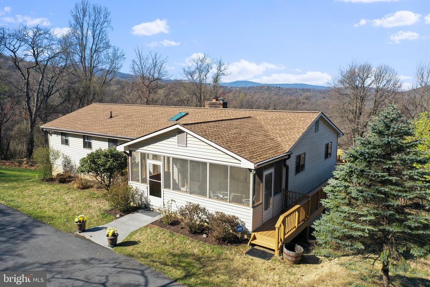 QUALITY & QUANTITY! Do not be fooled - this home has distinction and space inside!
 MAIN LEVEL includes 2 spacious bedrooms w/2 bathrooms. Open floor plan of eat-in kitchen space, bar, and large living room – all with cannot-be-beat mountain views! Spacious laundry room with storage. The dining room can serve as an office/den.  Relax by the beautiful stone fireplace with just a click of the remote control or sooth your soul in your jacuzzi tub.
 LOWER LEVEL has great views too!  2 bedrooms and full bath, huge family room, wet bar, and flue for a woodstove.  Utility room includes workspace, tons of storage, and freezer.
 FRONT SCREENED PORCH offers additional space to check out the outdoors, wildlife, and tranquility of mountain living.
 DETACHED GARAGE has a shocking amount of space with the handyman in mind when designed  with 220v and ample lighting/outlets.
 OUTSIDE, you will appreciate the amount of yard space, as well as, the multi-tiered enclosed garden spaces.  Level, paved driveway w/plenty of parking. The oversized 2-tiered deck is what dreams are made of—sip your coffee/wine or work from home all while taking in the fantastic views, evening sunsets, and peaceful stargazing!
Owner of the home took great care in using quality materials and craftsmanship throughout the house. 2023 upgrades include new roof and modernization of lower level.  Additionally, all kitchen appliances have been recently upgraded to top-of-the-line. Make this your forever home or a perfect second home getaway!
 Make note: Additional 2.66 ac. adj lot can be purchased. MLS# VAWR2005274