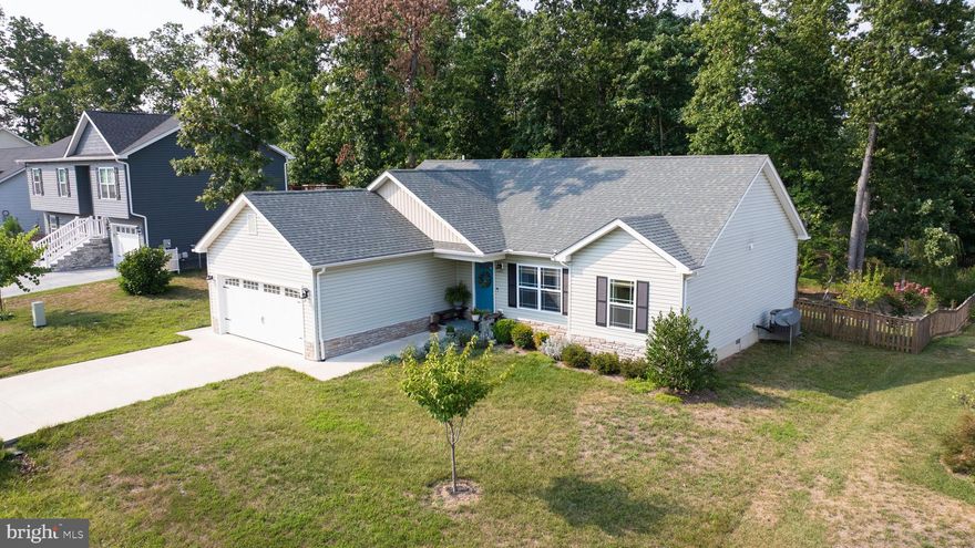 Welcome to this stunning rancher, built in 2019, where modern luxury meets serene country living. This immaculate 3-bedroom, 2-bathroom home boasts an array of upgraded features and thoughtful details designed for comfort and convenience.

Step inside to discover elegant vinyl flooring throughout, complemented by vaulted ceilings and wide designer interior doorways for enhanced accessibility. The heart of this home is the gourmet kitchen, updated in the fall of 2021, which includes top-of-the-line appliances, granite countertops, and a spacious island perfect for extra seating and entertaining. The adjoining dining area and living space are warm and inviting, highlighted by a cozy gas fireplace.

The primary suite is a true retreat, featuring his and hers closets and a luxurious en-suite bathroom with cultured marble tops, integrated bowls, and stylish brushed nickel Moen fixtures. Additional bathroom amenities continue the theme of elegance and functionality.

Outside, enjoy the tranquility of a large, partially wooded, and extensively landscaped rear yard, complete with a newly added fence (2020) featuring two gates, including a convenient double gate. The concrete patio, accessed via patio doors, is ideal for outdoor gatherings and relaxation.

Other notable features include a 2-car garage with an electric vehicle charging station, a water softener installed in 2022, and a thoughtful layout that combines privacy with easy access to major commuting routes and shopping.

Don’t miss your opportunity to own this beautifully maintained home that offers both modern comforts and a peaceful retreat from the hustle and bustle. Schedule your viewing today!