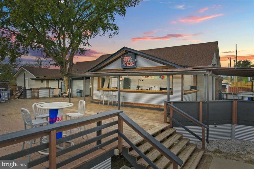 Absolutely One of a Kind in the area!  This large very successful bar/restaurant features over 5000 sq feet inside and over 2000 sq ft of outdoor deck space and another over 2000 sq ft of concrete patio around the stage.  Live out your dreams with this one.  Huge bar inside, fully operational and equipped outdoor bar, full size sand volleyball court, stage for the biggest bands, plenty of indoor and outdoor dance space, and more.  Touch of Texas has been in business at this location for years and has held events of over 2000 patrons.  There is additional parking out back on property owned by the current owner.  The property features over 60 paved parking spots.  This place is state of the art, with full lighting and sound system, security cameras, and more.  There are plans in hand to increase the size of the restrooms and kitchen.  There is no hood at the present time, as the current owner focused on bar food only.   There is plenty of room to expand the kitchen area.  All equipment necessary to open is included in this sale.  Negotiable are the industrial ice maker, two door freezer, taxidermy bull head, and bucking bronco set up.    Depending on your use, all can be included in the sale based on offer terms and conditions.   There is a 50' Easement to the Right side of the parking lot