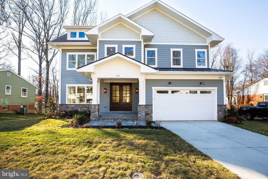 A MODERN CLASSIC...a beautiful combination of the Craftsman style with today's coveted amenities.  With thoughtful design and flow, this 5 bedroom 5.5 bath will not disappoint even the most critical of eyes.  Quality is expressed in the details and this home leaves nothing left to be desired.  The exterior boasts over-sized 3 foot awnings to protect the hardy plank siding from the elements and provide shade to the upper level on those hot summer days. The over-sized picture windows leave a clear view of the wooded lot and a trex style deck designed for entertaining or just enjoying the outdoors.  The interior is well appointed with Mahogany double front doors, 3.5in oak hardwood floors, recessed lighting, over-sized doors to compliment the 10' and 9' ceilings, 5 piece crown molding, bull-nose edged walls and so much more.  On the main you will discover a grand foyer flanked by sun-drenched rooms including a library with custom built-in cabinetry, a formal living room, formal dining space ,casual family room and a grand eat-in gourmet chef's kitchen equipped with wet bar, GE Profile appliances, wine refrigerator, 42" soft-close cabinetry and waterfall island.  At the garage entrance into the home you will be glad to find a mudroom and a walk-in coat closet. The second floor boasts a family lounge with custom built-ins, 4 bedrooms, each with an en-suite bath including the Master Suite and Bath.  Your private oasis awaits with the Master Suite.  A freestanding soaking tub compliments the standing shower offering either option to bathers. Separate vanities flank the entrance to the bathroom leaving plenty of room for two. Finishing off the master suite are two walk-in closets outfitted with custom built-ins.  You will most certainly enjoy the convenience of a second level laundry room ready and waiting for your favorite washer and dryer.  The basement level does not disappoint with full size windows and walkout double doors to your backyard. Entertaining will be a breeze with your wet bar equipped with custom cabinetry, wine refrigerator and bar to lounge.  Rooms included on this level are the main living space, guest bedroom, full bath, exercise room and movie theater room wired for sound. Don't miss the opportunity to live in this magnificent home with all the convenience of modern features but with the elegance and simplicity of the craftsman style.