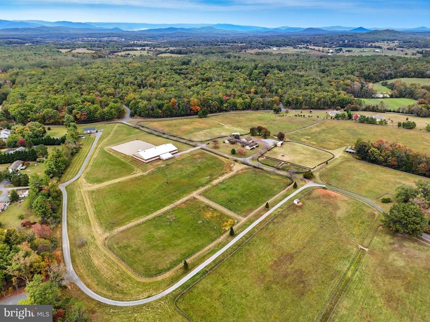 Opportunity Awaits! Ideal turnkey equine-oriented property for an active boarding and/or training facility on 14+ acres.  Enter down a gorgeous cherry tree lined driveway to the barns and indoor/outdoor arenas. The stable side contains 14 fully matted stalls across two barns - 8 in the main barn and 6 in the addition. Complete with two wash stalls, complete with hot/cold water, two large tack/feed rooms (one of which is heated), hay loft, half bath and a 1-2 Bed/1 Bath apartment.  The indoor arena offers 160x80 or nearly 13,000 sq/ft of well-lit space and an adjoining 24x36 annex with two offices/bedrooms, one full bath, large common/lounge area, utility/laundry, kitchenette and oversized plexiglass windows allowing for comfortable viewing.  The indoor area opens directly onto a 150x150 outdoor arena, complete with covered gazebo. 6 separate fenced paddocks, several with run in sheds and water run to most.  Well thought out driveway system ensures you'll have plenty of room to park and never had to back your trailer up. The stables and the arena both offer 50-Amp RV hookups for visitors, vets, etc.  A short trailer ride to incredible trail systems ... 15 minutes to Culpeper, 20 minutes to HITS and close to several Hunt Clubs. Looking to build your home close by? Additional adjacent 10-acre estate lot available for sale. Don't miss this opportunity.