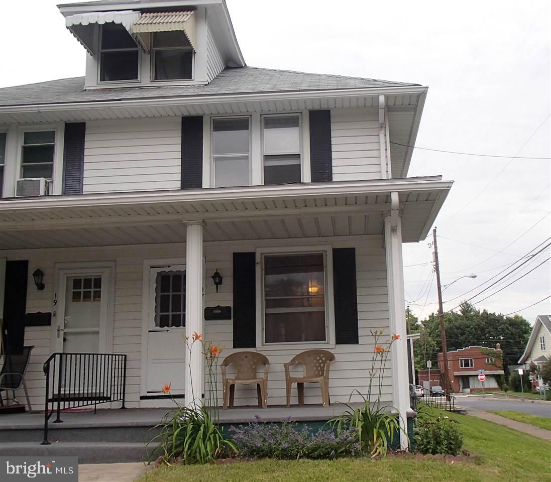 Great for investor or first time buyers. Move right into this well maintained home on a corner lot, featuring 3BRs, 2 full BAs, eat in kitchen or large Living room can be combined w/ dining room. Gas heat, new roof & new 200amp electric service installed in 2013. Plenty of storage in the attic and walk out basement with painted cement floor. Relax on the covered front and back porches. 3 garage can be rented for EXTRA income. Home is across from the municipal building, park and library. Excellent location.
