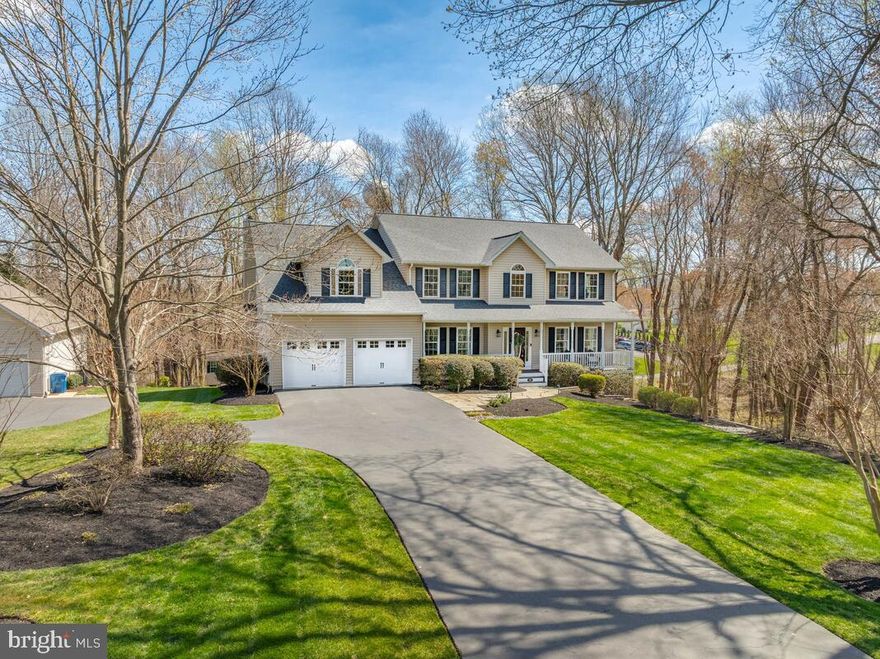 Nestled on a quiet end lot of a semi private drive, this impressive home offers a peaceful retreat with serene views of the surrounding woods. Featuring approximately 4,870 sqft of finished living space, 5 spacious bedrooms and 3.5 bathrooms, the residence is perfect for anyone seeking tranquility without sacrificing modern conveniences. The complete kitchen remodel boasts a gas stove,  while the updated wood flooring throughout the main floor adds a touch of elegance. Enjoy summer afternoons on the expansive 600 sq ft private deck, built in 2019, or relax in the basement media room equipped with stadium seating for six and a 120” screen. Recent renovations include a new roof (2017), custom office built-ins, an 80-gallon commercial-grade water heater installed in 2024, and 9’ ceilings throughout, this home is a blend of comfort and luxury.