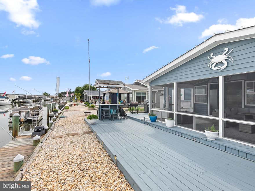 Wake up to the water every day in this beautifully kept 2-bedroom home in Mariners Cove, complete with your own private boat slip! A huge screened porch, sunroom with half bath, and large deck make it easy to enjoy the bay from your morning coffee to the evening sunsets. Well maintained and full of thoughtful updates, this 2-bedroom, 1.5-bath waterfront MODULAR home in Mariners Cove offers character and comfort that the newer, cookie-cutter mobiles often lack. With traditionally-built-home features, inside and out, this waterfront residence feels inviting year-round.
Enjoy evenings on the huge screened porch, relax in the welcoming sunroom, or gather on the spacious deck overlooking the dock and water. Inside, the kitchen features an extended countertop that doubles as a dining space, making everyday meals simple and casual, and there's a lovely corner fireplace in the living room for chilly nights. The 12x24 shed with electric, workbench, and pegboard is ready for hobbies, or storage of your fishing gear and golf cart. 
Behind the charm is real peace of mind: PVC and copper plumbing, a fully encapsulated crawlspace with sump pump and French drains, and years of attentive maintenance. This is a home designed for comfort, not just for weekends!
When you’re ready to head out on the bay, your private boat slip is just steps from the door, offering direct access to Rehoboth Bay for boating, fishing, or simply enjoying the water. Skip the traffic and the hunt for parking: Rusty Rudder in Dewey is just a short 20 min boat ride away!
. At $129,900, this home is one of the lowest-cost waterfront homes in Sussex County.
If you’ve been looking for a great condition, full-time water-access home with character, charm, and direct bay access, this one is ready to welcome you! Mariner’s Cove offers a beautiful pool, covered picnic pavilion, clubhouse/game room, boat slips and a boat ramp. With ongoing bulkhead and dock replacement being made by the park owner, noticeable improvements in drainage have already been achieved, reducing water accumulation along the roadways and yards, enhancing your waterfront living experience. Just 5–7 minutes away from shopping, dining, and all conveniences. A park application, including credit, background, and income/asset verification, is required for residency. *Modular homes are not the same as mobile and manufactured. They are built with wood framing, just like traditionally built homes, and sit on block foundations. There are no wheels underneath, and no steel chassis to corrode in the salt water environment. The subfloors are sturdy plywood, rather than particle board, and the home features traditional double pane, energy efficient, vinyl-clad windows.