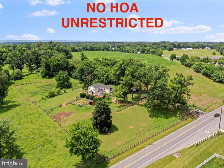 No Hoa! Unrestricted! 
Step into timeless charm with modern flair at 2587 Flowing Springs Rd., Ranson, WV.—a beautifully renovated 1900s colonial farmhouse nestled on 2 serene acres. With 4 oversized bedrooms, 3.5 baths, and 3,500 square feet of living space, this home offers the perfect blend of historic character and contemporary comfort.

Inside, gleaming hardwood floors flow through an open-concept layout, leading to a gourmet kitchen outfitted with black appliances, double ovens, and a spacious cooktop—ideal for the passionate home chef. Tray ceilings and thoughtful finishes add elegance throughout, while a newer roof ensures peace of mind. Shingles replaced in 2020.

But the charm doesn't stop at the front door. Outdoors, the property is fenced and ready for your horses, complete with a run-in shed and a cozy chicken house - perfect for those dreaming of a mini farm.

Whether you're entertaining in the expansive living areas or enjoying quiet mornings on the porch, this home delivers the country lifestyle with modern convenience. Located just minutes from downtown Ranson and commuter routes, it’s a rare find that balances privacy with accessibility.

Don’t miss your chance to own this slice of West Virginia charm. Schedule your showing today