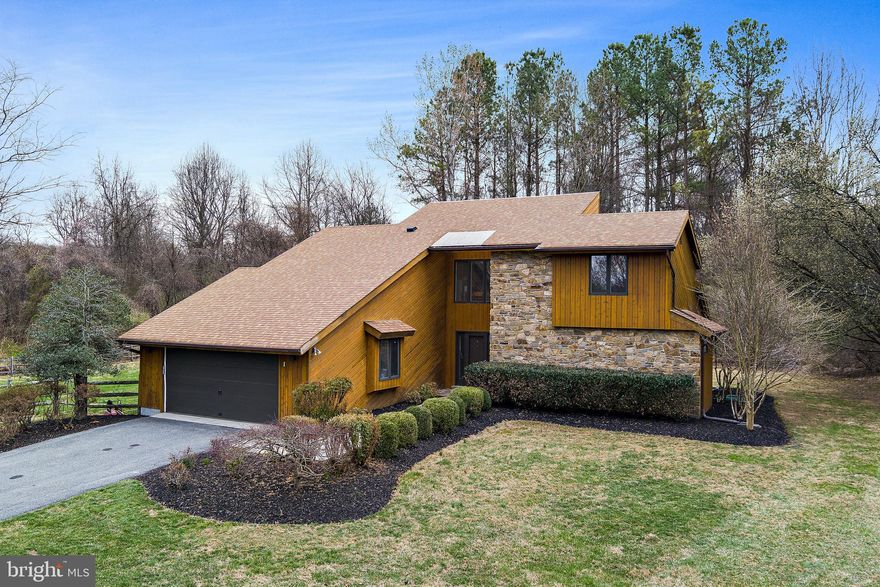 This stunning contemporary home with over 60K in upgrades is tucked away in a private cul-de-sac, offering a peaceful retreat on three beautiful acres in the heart of Highland. This thoughtfully designed home showcases a stone, wood-burning fireplace as the focal point on the main living area. The home has been freshly painted inside and out, with updates to the cedar and stone exterior enhancing its modern appeal.
The first-floor primary suite provides the ultimate convenience, featuring an en-suite bathroom and a brand-new sliding door that opens to a private Trex deck—a perfect spot to unwind. The recently updated kitchen is designed for both style and functionality, with rich wood cabinetry, quartz countertops, and stainless steel appliances. A second sliding door off the kitchen leads to another Trex deck, ideal for outdoor dining. Hardwood flooring flows throughout the main level, while brand-new carpeting has been installed upstairs. All bathrooms have been refreshed with new lighting, mirrors, and faucets that complement the home’s sleek, contemporary design.
The finished lower level adds even more living space, offering a bathroom, a bonus room that can be used as an office or hobby space, and plenty of storage. Outside, the home is set back on a long driveway, providing privacy and ample parking. Expert landscaping creates a picturesque setting with hardscaped walkways, new trees, and vibrant flowers that will bloom beautifully this spring. The fenced-in yard adds an extra layer of privacy and security.
While this home feels like a private retreat, it’s just minutes from major commuter routes, shopping, dining, and conveniences in Clarksville. Downtown Columbia is also a short drive away, offering even more amenities. Welcome home!