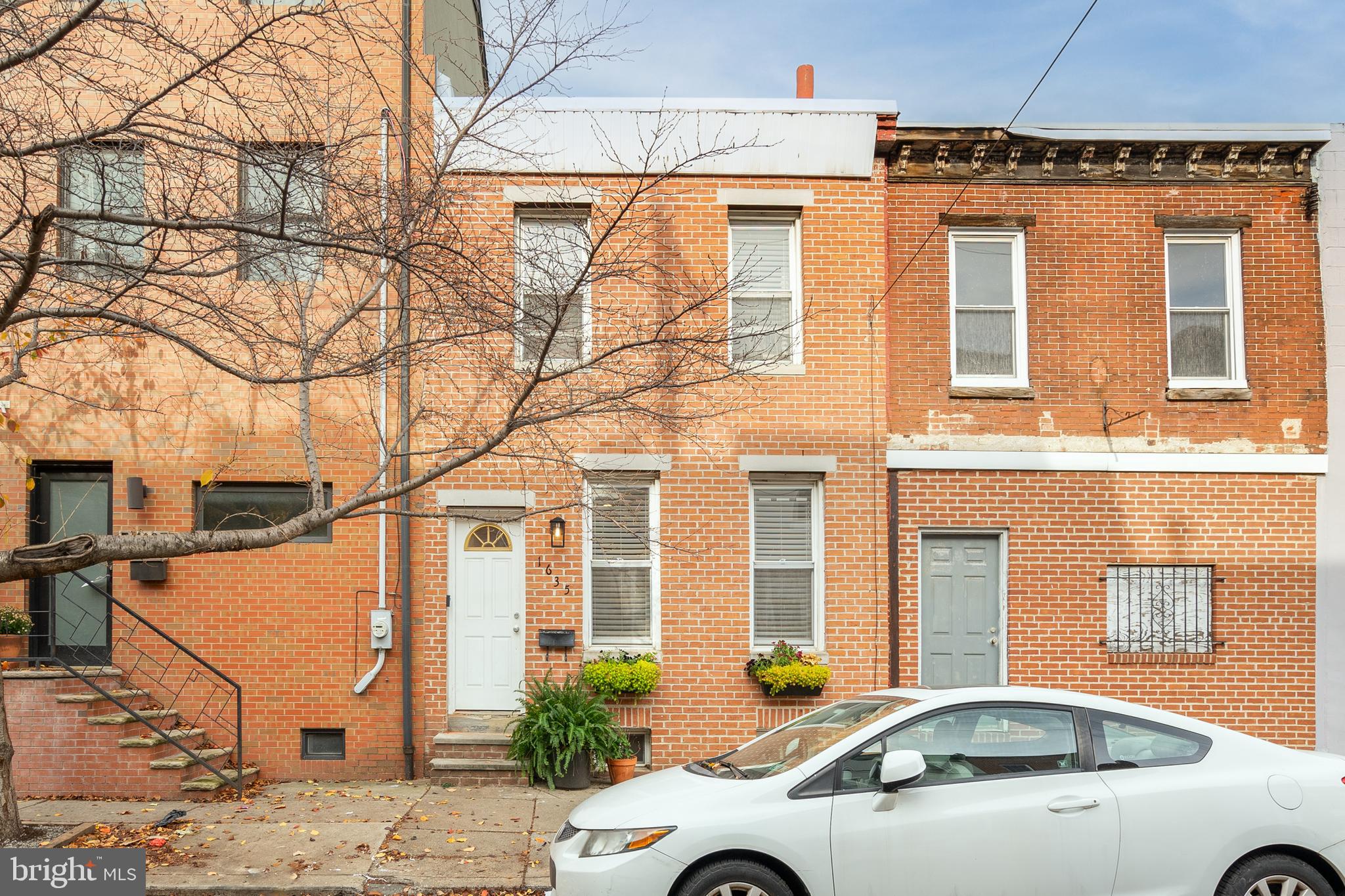 Welcome to 1635 Catharine St, a charming and updated 2-bedroom, 1-bath home in the heart of Graduate Hospital, offering an easy walk to Rittenhouse Square. The classic red brick façade with lush planters adds curb appeal, while inside, high ceilings, hardwood floors, and oversized windows create a bright and inviting atmosphere. The open living and dining areas easily accommodate gatherings, and the stylish kitchen boasts granite countertops, stainless steel appliances, and a subway tile backsplash. A private patio extends the living space outdoors, perfect for dining, gardening, or relaxing. Upstairs, the sunlit primary bedroom features modern flooring, two closets with built-in organization, and ample natural light, while a second bedroom and a beautifully designed bathroom with brass-tone fixtures and a soaking tub complete the level. The lower level provides great storage and laundry space, adding to the home’s practicality. With a Walk Score of 98, you’re steps from South Street’s vibrant shops and restaurants, as well as Rittenhouse Square’s renowned dining, shopping, and entertainment. Nearby essentials include Target, Sprouts Farmers Market, and Wine & Spirits, plus the Schuylkill River Trail for outdoor recreation. Commuters will appreciate the easy access to public transit, Center City, University of Penn, Washington Ave, Broad St, and I-76. Schedule your tour today!