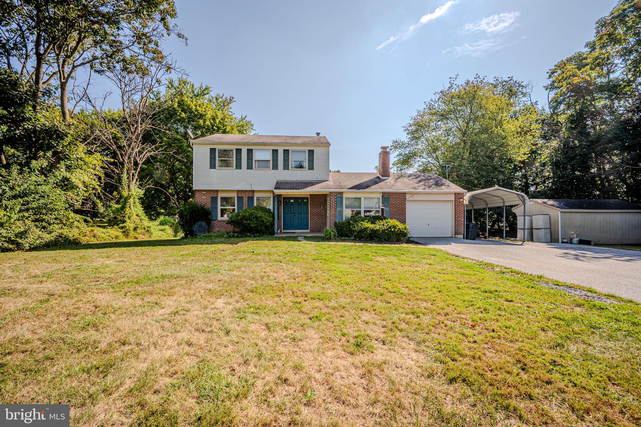Tucked amidst nature on 1.1 acres, this 3 bedroom brick colonial has everything you need! Step inside to parquet flooring and into the living room with lovely natural light and adjoining dining room with crown and chair moldings. Flow into the eat-in kitchen with bright white cabinetry and a lovely view outside from over the sink. The sunken family room features recessed lighting, custom built-ins, and cozy wood-burning fireplace. Outside, enjoy a completely private & peaceful view from the screened porch and large deck; the ideal setting to dine, relax, and enjoy a front row seat to the changing seasons. Back inside and upstairs, you will find all 3 bedrooms (2 with double closets), a full bathroom, and linen closet. A full basement offers plenty of storage, and bonus features include a large shed for storage, an oversized driveway and carport for plenty of parking options. Convenient access to the Blue Route and 322 for commuting, the location is ideal. Be sure to view the virtual tour and schedule a showing today!