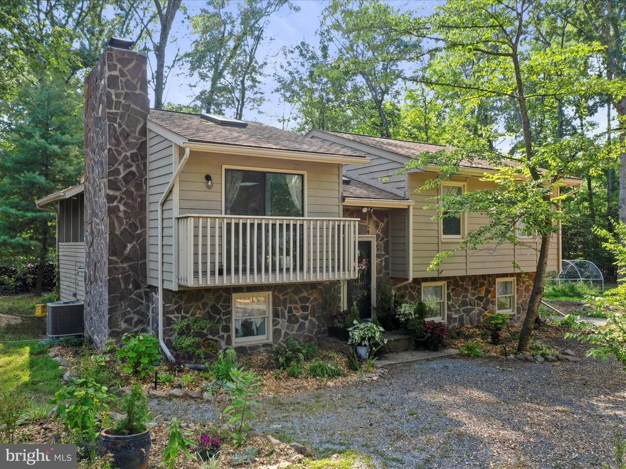 This charming three bedroom, two bath split foyer home is nestled on a spacious .98 acre lot, offering the freedom of unrestricted living. The property is adorned with several garden structures, fruit trees, chicken coop, outdoor sauna, smokehouse, making it ideal for a self-sustaining lifestyle. Inside, the main floor is bathed in natural light thanks to skylights throughout, while LVP flooring provides a stylish and durable foundation for the entire home. The large, screened in porch and freshly painted deck offer perfect spaces for outdoor relaxation and entertaining. The home features custom barn doors and farmhouse style decor, adding rustic charm to the interior. The kitchen boasts freshly painted cabinets and butcher block countertops, ideal for cooking enthusiasts. The wood burning fireplace in the living room and the wood stove in the finished recreation room add a nice touch of warmth and charm, while the upgraded bathrooms and separate entrance into a versatile room provide modern convenience and flexibility. This property is perfect for nature lovers and commuters alike. With water access, proximity to the Appalachian Trail, and historic Harpers Ferry nearby, it offers plenty of opportunities for outdoor activities. Additionally, its location makes it a convenient option for those commuting to DC, VA, and MD. The roof and gutters are 5 years old, the HVAC is 4 years old, there is a triple water whole house filtration system with additional ceramic filter in the kitchen, active radon mitigation system,  chimney was professionally cleaned and inspected 2/24, septic pumped 11/20. There is enough firewood to last many years that is nicely stacked too! There is a detached garage for storage with a separate electric meter, and a nice parking pad for your RV. Currently growing apples, peaches, thornless blackberries, currents, elderberries, asparagus, rhubarb, tomatoes, watermelons and muskmelons, winter and summer squash, six different types of herbs, kale, collards, chard, green beans, 17 different varieties of sweet and hot peppers, broccoli, kohlrabi, beets, cauliflower, and cucumbers. This property has been very well loved and maintained. Schedule your showing today!