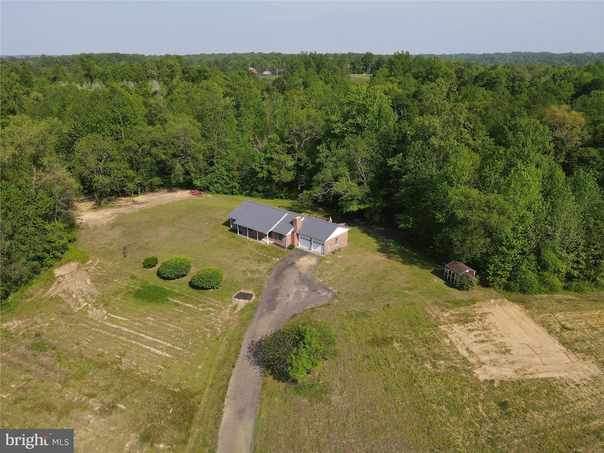 Price Improvement! Don’t miss this rare opportunity to own 7.35 acres in Prince George’s County’s sought-after Rural Tier. Zoned AG (formerly OS), this property is ideal for a farmette, equestrian use, or private estate living. No HOA or covenants. The all-brick rambler features a durable steel roof, attached 2-car garage, and a custom brick fireplace ready for a wood stove. Interior highlights include a spacious country kitchen, cozy family/living room, and a large 24’x16’ rear deck perfect for outdoor entertaining. The huge partially finished basement has a full bathroom, a storage room, laundry room, a hobby room that can be used as a possible 4th bedroom and a large recreational room with unlimited potential. There is a chimney flue access to also add a wood stove / pellet stove to the basement as well! The shed and run-in are sold as-is. Set on a private, wooded lot accessed via a shared gravel road, the property is currently farm-assessed for lower taxes. Located along the Legacy Wine Trail, and just minutes from Merkle Wildlife Sanctuary, Jug Bay, and the Patuxent River Park system. FIOS Internet is available at the end of the driveway. Reasonable commute to Washington, D.C. metro area. A minimum of 5 acres per dwelling unit applies under AG zoning. The seller will not pay for the Agricultural Transfer Tax into residential use. All showings must be scheduled in advance. Buyer's representative must be present at all showings.
