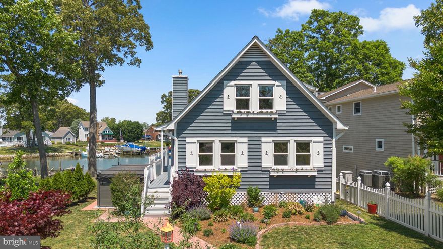 Welcome to this exceptional 2,100+ sq. ft. waterfront home on the protected waters of Lake Placid, offering direct access to the Magothy River. Situated on a rare, large, level lot, this property perfectly balances luxury, coastal charm, and top-tier mechanical upgrades.
Waterfront & Exterior Highlights: 
 An absolute paradise for boaters, the exterior features a private deep-water pier (4 ft. MLW) equipped with two slips, an 8,000 lb. boat lift, and a floating dock. The outdoor entertaining space centers around an elevated wrap-around deck with a retractable awning, which seamlessly transitions down to a lush lawn sloping gently to the water's edge. A large swim spa offers recreational resistance swimming as well as the health benefits of a jacuzzi spa. Ample storage and parking are provided by a detached two-car garage, two separate storage sheds, and a walk-out basement ideal for additional recreation room.
Interior Features:
 Inside, an inviting open-concept main level showcases refinished hardwood floors, two fireplaces, two bedrooms, and a full bath. The updated gourmet kitchen is equipped with premium granite countertops, a center island, and stainless-steel appliances. The architectural centerpiece of the home is a spectacular two-story, four-season sunroom with floor-to-ceiling windows offering panoramic, year-round water views. Upstairs, the private primary suite features elegant French doors that open to an indoor balcony overlooking the sunroom and provides spectacular river views below.
Systems & Community:
 Meticulously maintained, the home features premium infrastructure upgrades including a high-efficiency Geothermal HVAC system and an advanced water treatment system. Residents also enjoy the premier amenities of a vibrant, water-privileged community, including a private beach, boat ramp, clubhouse, playground, and basketball courts.