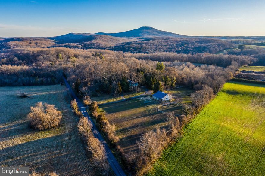 Take advantage of this rare opportunity to live on your very own horse property situated on 5.5 wooded acres on the former Dr. Belt Estate in serene Dickerson. Enjoy fantastic views of the mountains, including Sugarloaf Mountain and  the idyllic countryside! This mid-century modern home features one-level living with 3 bedrooms and 3 baths and custom features including slate flooring, loads of floor-to-ceiling windows and stainless steel countertops in the kitchen! Bring your imagination for the quaint guest cottage on the property and make it your own! Enjoy the best of both worlds--easy access to major commuter routes (including I-270/355 and only one mile from the  MARC station) and shopping (Clarksburg outlets/ Frederick), while still enjoying peaceful country living. Experience the outdoors, with easy access to the C and O Canal Towpath and the historic Monocacy Aqueduct. Ride the trails at Sugarloaf Mountain or the Monocacy Natural Resources Management Area Trails. Admire the natural beauty surrounding the home while also enjoying the beauty inside the home. This property is horse-ready--with an updated horse barn with water and electric, seven stalls, tack room, pasture, pole shed--it has it all! Take advantage of this rare opportunity!  ***  Check out our Zillow 3D Video  ***  https://www.zillow.com/view-3d-home/9747a192-cd73-4460-9125-c52cb576a58f?setAttribution=mls  ***  Check out our Walkthrough Video  ***  https://www.youtube.com/playlist?list=PL0j7p96aFtsU_5uQeCqVVpw_paN9wt_CW
