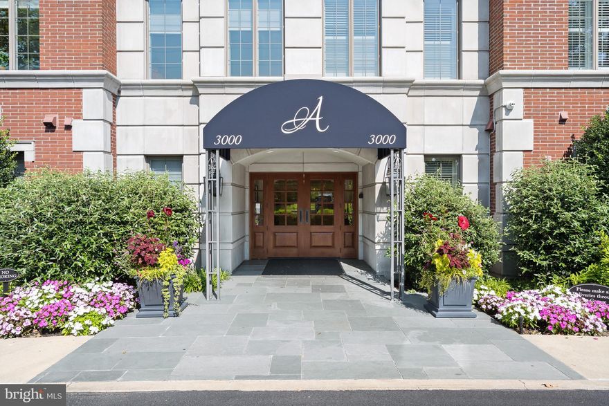 Welcome to Athertyn- a lifestyle community by Pohlig Builders.   This premier corner location Furness floor plan provides luxury one-floor living overlooking the wooded viewsheds of Haverford Reserve.   The coveted two Bedroom plus Den/two and a half Bath home features a Gallery entrance leading to an open floor plan bathed in sunlight that only a Southwest exposure can provide!  Custom features and upgrades abound, including maple hardwood flooring throughout all main living spaces, arched cased openings, custom built-in cabinetry, gas fireplace with floor to ceiling custom mantle detail, study pocket doors. plantations style shutters and more.  The Kitchen features Kountry Kraft cabinetry with custom hood detail and oversized Island complete with ceramic tile backsplash and quartz countertops.  Beyond the heart of the home, you will find a gracious Primary Suite with bay window, dressing room, two full walk in closets and luxurious Primary Bath.  Thoughtfully situated on the other side of the home are Guest Suite with Full Bath, Pantry Closet and full sized Laundry Room.  The half bath is central and convenient for entertaining, just across from the Study space which is perfect for a home office, cozy den, art studio or additional guest space.  Underground parking and storage are also included.  Athertyn is the centerpiece of Haverford Reserve, a 209 acre residential & preservation development complete with nature & biking trails.   Homeowners enjoy use of clubhouse, pool & spa, tennis & pickleball court, putting green & gardens.  Your new lifestyle awaits!