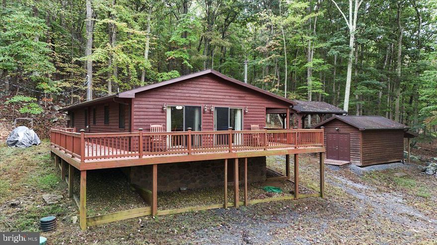 Escape to 384 Seneca Ridge, a cedar-sided cabin set on a wooded 3+ acre corner lot. This 4-bedroom, 2-bath retreat blends rustic charm with modern comfort—perfect as a vacation getaway or full-time residence. Inside you’ll find open living spaces, abundant natural light, and a cozy wood stove for year-round enjoyment.
Relax or entertain on the wraparound deck with gazebo, surrounded by peaceful forest views. A bonus shed with electricity provides extra storage or workshop space, and the gated circular driveway allows easy access and added privacy.
Outdoor lovers will appreciate deeded access to the Cacapon River, just a short stroll away, ideal for fishing, kayaking, and swimming. The septic system has been recently updated and approved for 4 bedrooms, supporting everyday living or generous guest accommodations.
This property delivers the ultimate mountain escape—privacy, tranquility, and endless outdoor adventure—while remaining convenient to Berkeley Springs and major commuter routes. Don’t miss this rare opportunity for a private retreat or year-round home!