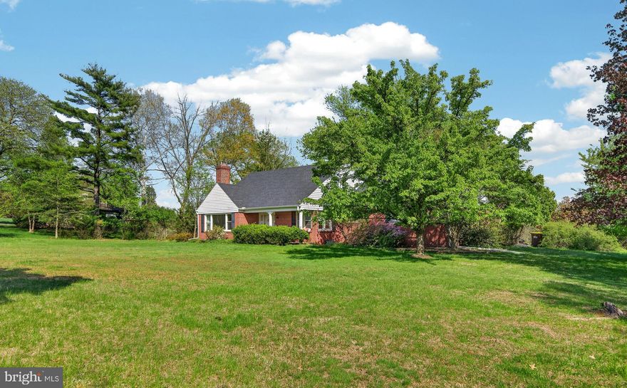 This charming 3 Bedroom, 3 full Bathrooms Cape Cod style home is set on a private and peaceful 1.96 acre lot. The Main Level features beautiful hardwood flooring in most of the first floor, a private bedroom with its own en-suite bathroom, a convenient Main Level laundry plus a bright, heated Sunroom perfect for year-round enjoyment. Additionally, the Main Level has a large Living Room with a fireplace and a wonderful Dining Room with bucolic views overlooking the back yard. A Den, set off the Living Room, could make a perfect Home Office. Chefs will love the Kitchen with its granite countertops and stainless appliances. Just steps away from the Kitchen is a spacious Family Room with a wall of south facing windows. Upstairs, you will find two additional bedrooms, including one with a private en-suite bath and a Primary Bedroom with access to a hall bathroom. Enjoy the tranquility of a quiet setting on the outside patio - the perfect space to relax or entertain. There is also a detached two-car Garage for added storage and convenience. Please note that the Garage’s loft area has been rough plumped so this area could make a great office. Most of the home’s Lower Level has been finished into a space the everyone will love. This property offers the perfect blend of comfort, functionality, and serene surroundings. Its location in an area of more expensive properties makes this home a great value!