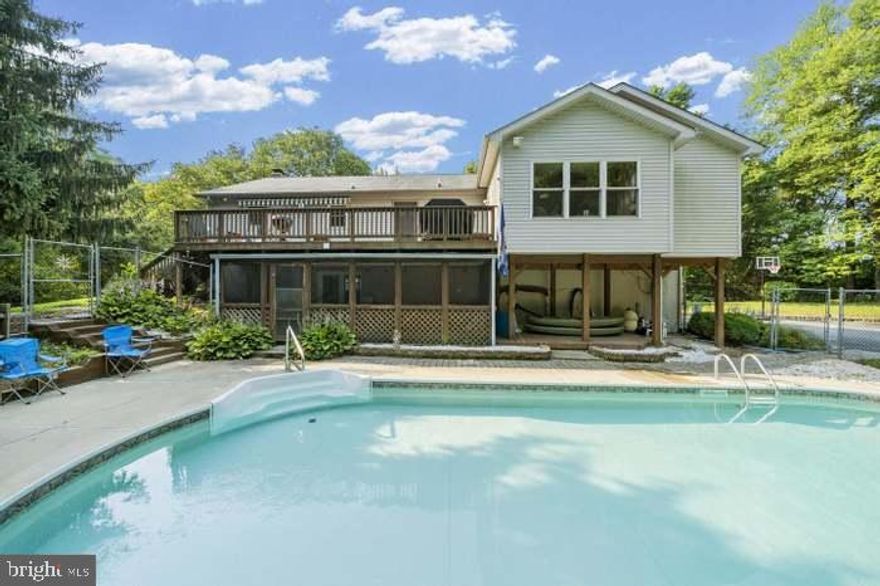 Single family home in a private oasis on a large 3.35 acre lot.  Privacy at its best.  Inground pool for your enjoyment.  Primary bedroom suite has an exceptional layout with a generous amount of closet space including a large walk-in closet in addition to 4 other closets.  Sitting room/office overlooks the pool and wooded area - very relaxing.  The primary bathroom features a built in towel warmer and other quality upgrades.  Hardwood flooring on main and lower levels.  2 wood stoves capable of heating the entire house.  Large, spacious kitchen with corian countertops, stainless steel appliances, island and a generous space for dining.  Kitchen provides access to the deck on the upper level.   The well pump was replaced 2 years ago and has a 30 year warranty.  The washing machine was purchased last year.  Don't miss this great opportunity.