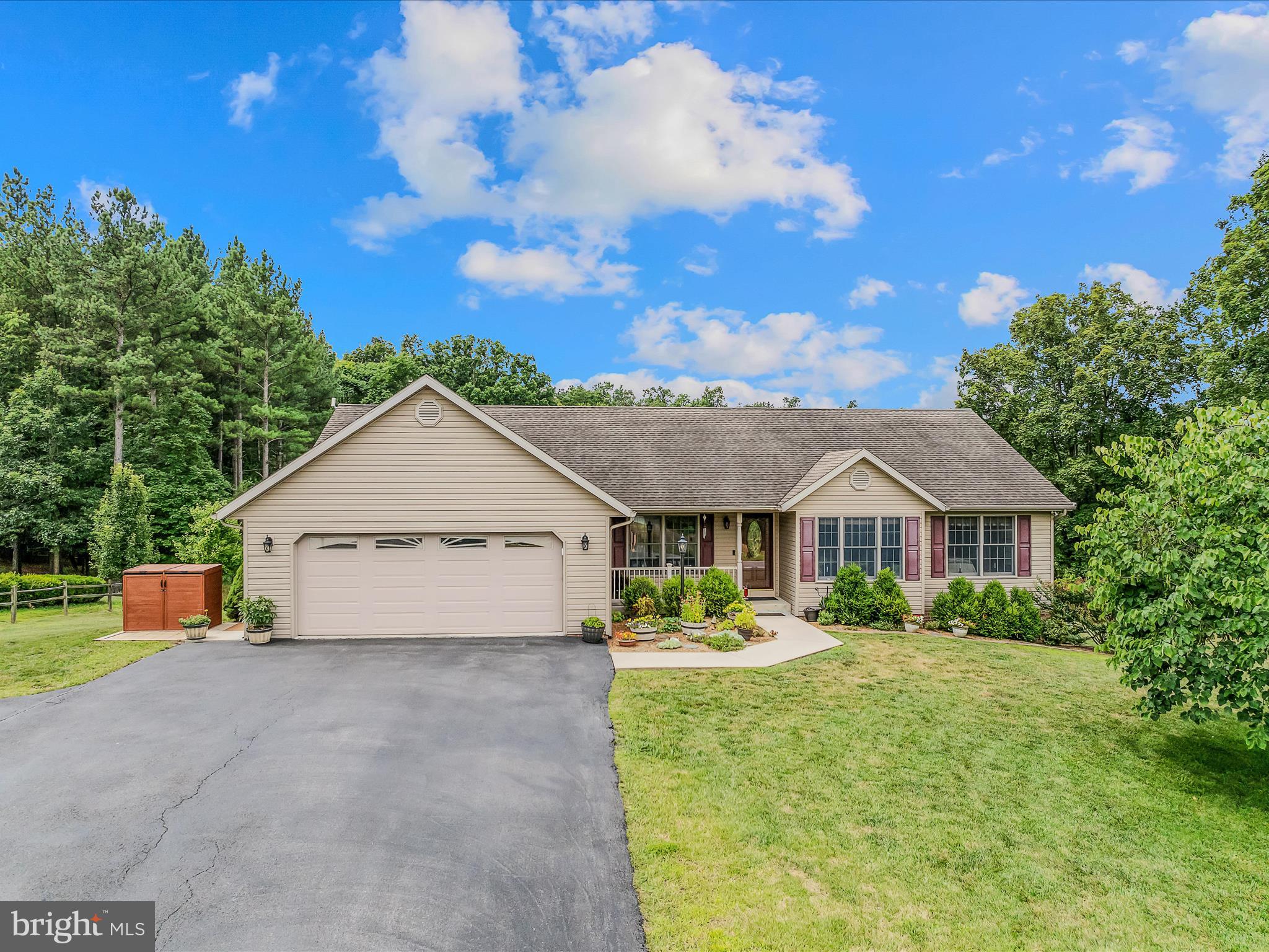 Picky buyers welcome! This beautifully built 4-bedroom, 2.5-bath ranch home in the desirable Fairview Oaks community offers over 2,000 sq ft on the main level of quality craftsmanship by a locally respected builder. Conveniently located just minutes from the hospital, downtown Berkeley Springs, and with easy access to I-70, this spacious main-level layout is perfect for entertaining. The open-concept living, dining, and kitchen area features newer Kitchen Aid ss appliances including a double oven, granite countertops, dual pantry areas with easy access slide outs, breakfast bar, hardwood floors and a cozy gas fireplace, while the split-bedroom design ensures privacy for the primary suite. A separate mudroom/laundry area connects the oversized garage to the living space, adding convenience and function. The improved unfinished basement offers endless potential including a separate garage area—create a family room, home theater, or finish to suit your needs. Enjoy the outdoors on the 12x24 back Trex deck with a retractable Sunset awning overlooking a scenic neighboring pond, and grow your own vegetables in the raised and fenced garden beds. External generator hook up. This is a rare opportunity to own a quality home with 1.18 acres in a prime location—schedule your showing today!