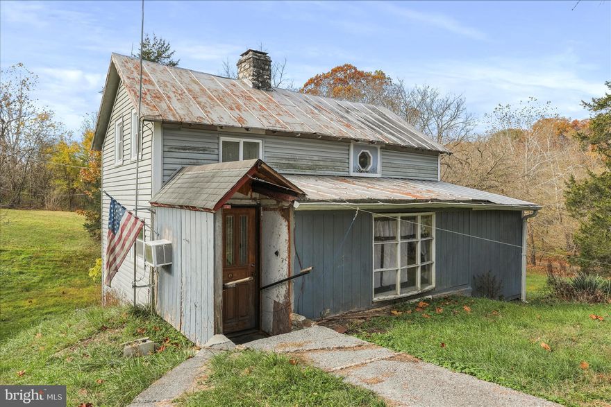 Discover this charming 3-bedroom, 1-bathroom farmhouse nestled in the serene Hidden River Farm community. Built in the 1900's, this detached home features traditional floor plans with hardwood flooring and a cozy stone fireplace, perfect for creating lasting memories. The property requires major rehab, offering a unique opportunity to customize it to your taste. Set on nearly 3 acres, the lot boasts a mix of open space and wooded areas, with direct access to the Opequon Creek, ideal for fishing, swimming, or kayaking. Enjoy picturesque views of the creek and surrounding pastures from your future outdoor retreat. Additional structures include a barn, enhancing the property's potential for various uses. Conveniently located in a rural setting, this property offers off-street parking and a gravel driveway. Embrace the tranquility of country living while being just a short drive from local amenities. This is a rare opportunity to create your dream home in a beautiful, unrestricted environment. Property contains 2 lots. Lot #97 contains the house and is 1.64 acres. Lot #98 contains the barn and is 1.3 acres.