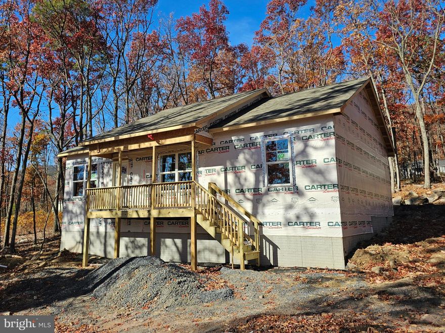 This is a fantastic opportunity to purchase a new construction home and have the ability to select the colors and finishes desired. The purchaser will have the ability to customize the home through numerous optional upgrades. This home will feature upgraded 2x6 exterior framed walls with R-21 insulation for added strength, energy efficiency, and improved soundproofing. Some standard features included are vaulted ceilings, granite kitchen countertops, shaker-style cabinets with brushed nickel hardware, recessed lighting, ceiling fans with LED light fixtures, luxury vinyl plank flooring, and a washer and dryer. The home pictured is a similar build on a different lot. This home will be a larger square footage than the one pictured, but will have the same design and elevations.  Wilde Acres community is located in western Frederick County, VA. The location offers outdoor enthusiasts numerous activities to pursue, including hiking, fishing, hunting, etc. The community features a common area with a stocked fishing pond, pavilion, and playground. Interior photos are of a similar home built by the same builder.