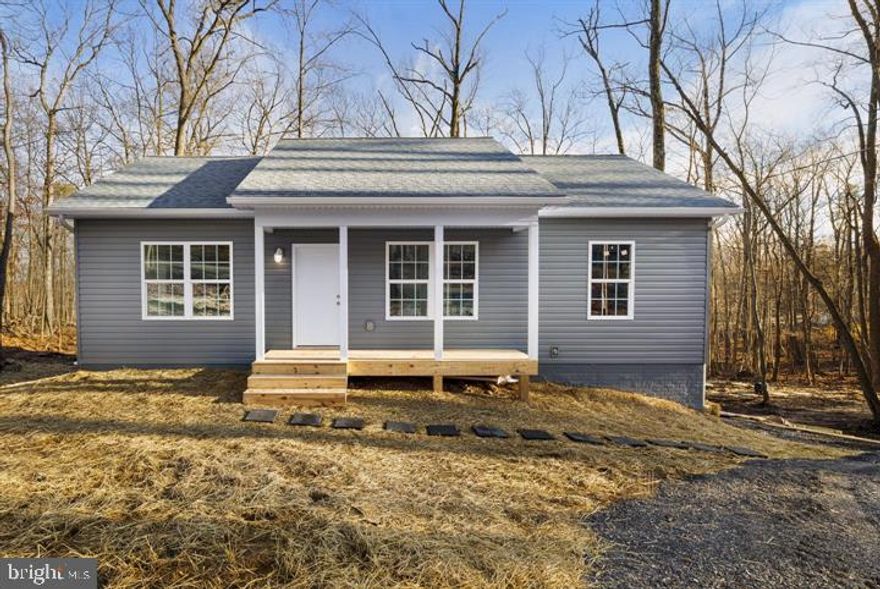 This is a fantastic opportunity to purchase a new construction home and have the ability to select the colors and finishes desired. The purchaser will have the ability to customize the home through numerous optional upgrades. This home will feature upgraded 2x6 exterior framed walls with R-21 insulation for added strength, energy efficiency, and improved soundproofing. Some standard features included are vaulted ceilings, granite kitchen countertops, shaker-style cabinets with brushed nickel hardware, recessed lighting, ceiling fans with LED light fixtures, luxury vinyl plank flooring, and a washer and dryer. The home pictured is a similar build on a different lot. This home will be a larger square footage than the one pictured, but will have the same design and elevations.  Wilde Acres community is located in western Frederick County, VA. The location offers outdoor enthusiasts numerous activities to pursue, including hiking, fishing, hunting, etc. The community features a common area with a stocked fishing pond, pavilion, and playground. Anticipated completion before Christmas 2025.  (Photos are of a similar build).