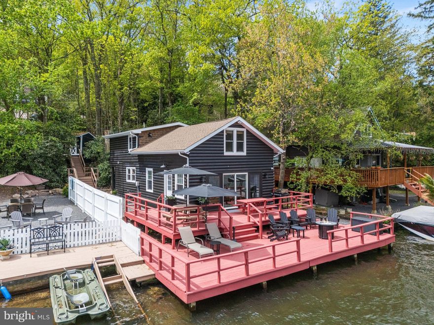 Experience lakefront living at its finest in this fully renovated and
designer-furnished retreat. 36 South Lake Drive is a 5-bedroom, 2-bath
getaway that blends rustic charm with modern comforts—all just steps from
your private dock and panoramic waterfront views.
Inside, the spacious layout comfortably sleeps 16 and features a 23x13
living room with sliding doors that open to a lakeside deck. The updated
kitchen includes a Samsung fridge, electric stove, microwave, and
dishwasher. A cozy bedroom with deck access for the early risers, and full
bath complete the first floor. Upstairs, four additional bedrooms and a full
bath with generous dimensions make hosting a breeze. Modern
conveniences include central AC, a water softener, recessed lighting,
high-end washer/dryer combo, and a remote-controlled HVAC system for
year-round comfort. Outside, gather around the private fire pit, store your
gear in two sheds (16x12 and 6x8), or relax under umbrella-covered seating
with the lake just steps away. This idyllic family retreat or lucrative rental
property includes private off-street parking for 8 vehicles. Immediately next
door is 34 S Lake Drive, which is also for sale. The seller of these incredible
properties may consider improved terms for buyers interested in purchasing
both properties. The sale includes all fixtures, furnishings, and appliances.
Virtual tour and floor plans are included with this listing.