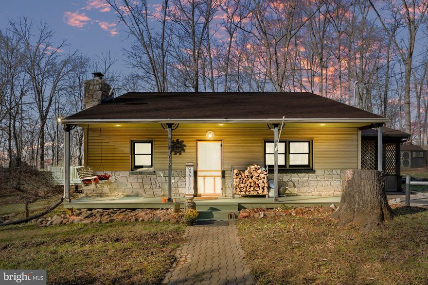 Offered for sale is this charming three-bed, two-bath country mountain retreat! This warm and inviting home would make a perfect full-time residence, second home, or Airbnb property. The home has been recently renovated with fresh paint and new flooring in all bedrooms. Other improvements include a new roof in 2018, new well pump in 2024, and a recently replaced washer, dryer, and refrigerator. The kitchen features gorgeous brown oak floors, crown molding, and a beautiful mosaic backsplash. Off the kitchen is a screened-in porch that serves as a great extension of living space during most of the year. The stone fireplace and wood-burning insert highlight the cozy living room. Imagine watching the snow falling outside while sitting next to a roaring fire! The primary bedroom offers an en suite bath, a walk-in closet, and a private deck. There is another large deck at the rear of the house, which is perfect for grilling and entertaining on those perfect summer evenings. A picturesque stone paver walkway leads to the charming covered front porch at the front of the home. This is a great spot to sit on the porch swing and take in the sights and sounds of the natural surroundings this lot provides. The front yard on either side of the walkway is absolutely filled with vibrant colors as the well-established perennials appear throughout the growing season. The rear and side yards offer ample garden space and feature a large shed and a chicken coop! An additional connecting parcel at the rear of the property is included in the sale. This property is located in an area with countless outdoor recreational activities nearby. Within one mile of this home (as the crow flies) are the Shenandoah River, Appalachian Trail, Shannondale Springs Wildlife Management Area, and The Mountain Lake Club. The Mountain Lake Club offers a beautiful 55-acre lake, a beach area, boat and kayak rentals, and a restaurant/bar. Other local attractions include Harpers Ferry Historic National Park, various white water rafting outfitters, fishing guide services, snow tubing, ziplining, an outdoor adventure park, and Harpers Ferry Brewery. The Shenandoah and Upper Potomac Rivers provide excellent fishing opportunities for smallmouth bass, walleye, musky, catfish, and numerous other species.  Schedule a private showing to see what this incredible property has to offer!