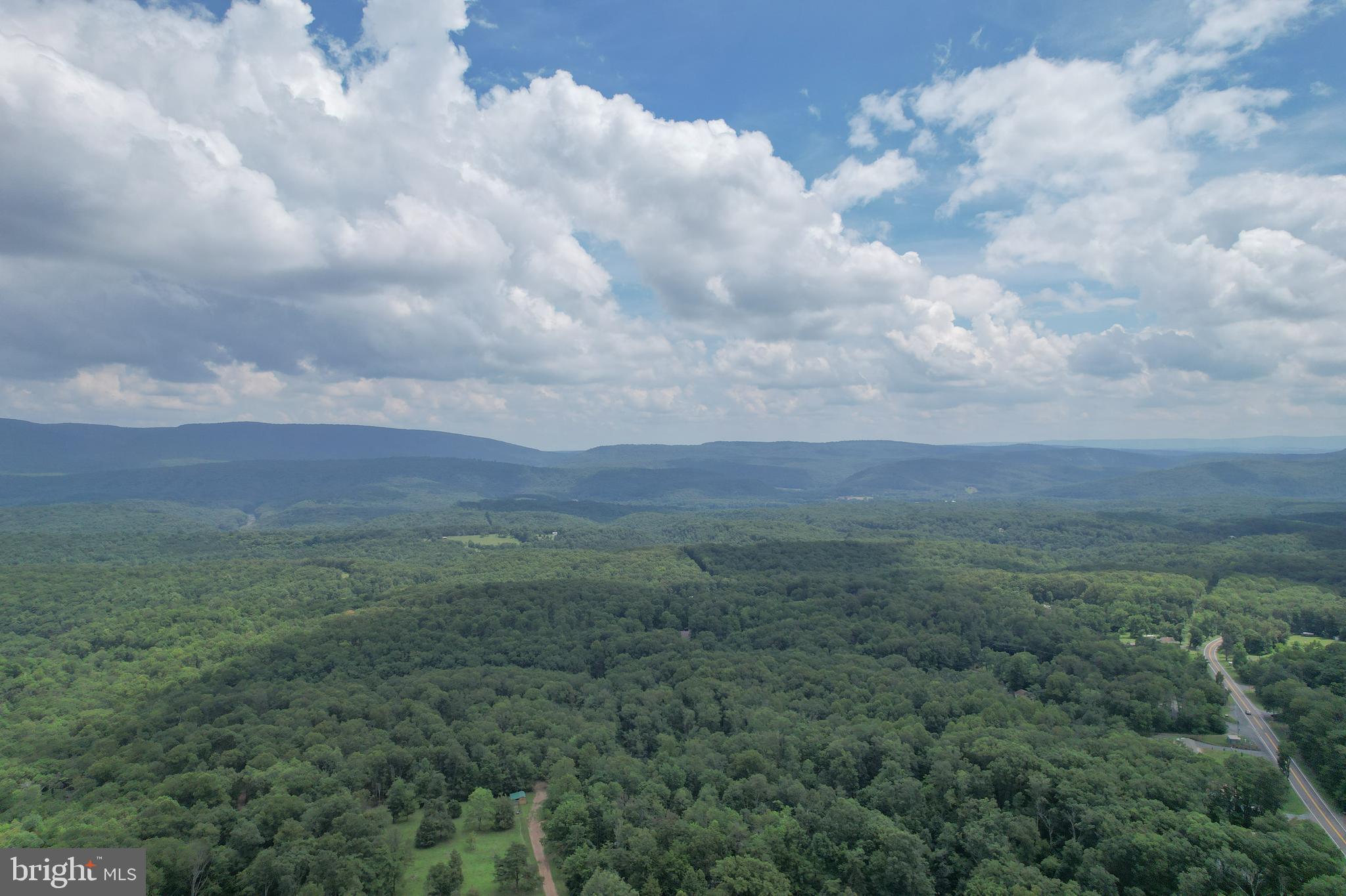 Ready to build your dream mountain home? This 5 acres corner lot is an divine opportunity to set up your mountain escape. Located within the rural Cacapon Heights neighborhood where privacy is paramount, this lovely parcel will make a gorgeous home site. The property is raw land and has not been improved or percolated for well or septic. Neighboring homes have been built in recent years as this mountain development continues to expand. A road maintenance agreement is in place for snow removal on the neighborhood roads which are mainly gravel and moderately passable at times. Make an investment in land in Hampshire County, West Virginia where wild meets wonderful! You can drive to the land, there are signs on the property. Property starts at the corner of Eastland Drive and Mountain Top Road and has road frontage on both sides. Driveway access was initially developed on Eastland Drive and is still somewhat accessible. Park at gates out of the roadway to walk/ access property. Do not trespass on other property.