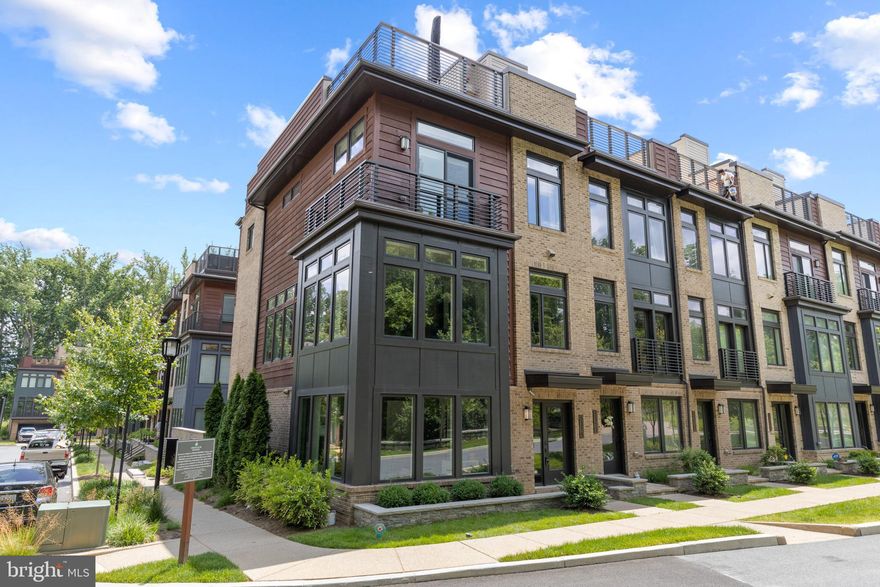 Click the Virtual Tour link to view the 3D walkthrough. Luxurious townhouse living in Grosvenor Heights! Conveniently close to Metro, Wildwood Shopping Center, all of the downtown Bethesda shops & restaurants, DC, and more. This end-unit home boasts 4 beds,  3.1 baths, and an attached 2-car garage on lower level. An incredible smart home system is included that controls the blinds, sound, televisions and lights. Everything conveys! Hardwood flooring throughout. Enjoy multiple living spaces on all three levels as well as a balcony off of the 2nd level and a spacious, private rooftop terrace with a built-in Viking grill, outdoor fireplace, and a wet-bar. Ideal to entertain or watch a movie (outdoor TV conveys). The designer gourmet kitchen is a dream- complete, with Thermador appliances, a kitchen island, granite countertops and recessed lighting. The living room has a lovely gas log fireplace and a hidden bar area with a wine fridge. Floor-to-ceiling windows open the space up and provide tons of natural light throughout and amazing views!! The primary suite boasts 2 separate WIC and ensuite bath with walk-in shower and double vanity. The downstairs office or guestroom also has an ensuite bathroom as well.